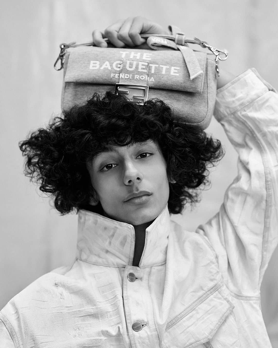 Fendiのインスタグラム：「"I am never one to shy away from an iconic bag." - Marc Jacobs  In #MarcJacobsXFendi, the designer applies his signature logomania to the #FendiBaguette.  Artistic Director of Accessories and Menswear: @silviaventurinifendi  Artistic Director of Jewelry: @delfinadelettrez Artistic Director: @themarcjacobs  Photography: @brunostaub   Styling: @ganio Makeup: @makiryoke Hair: @jimmypaulhair Set Design: @mattjacksonmattjackson  Casting: @piergiorgio  Model: Mehdi Abouzaid」