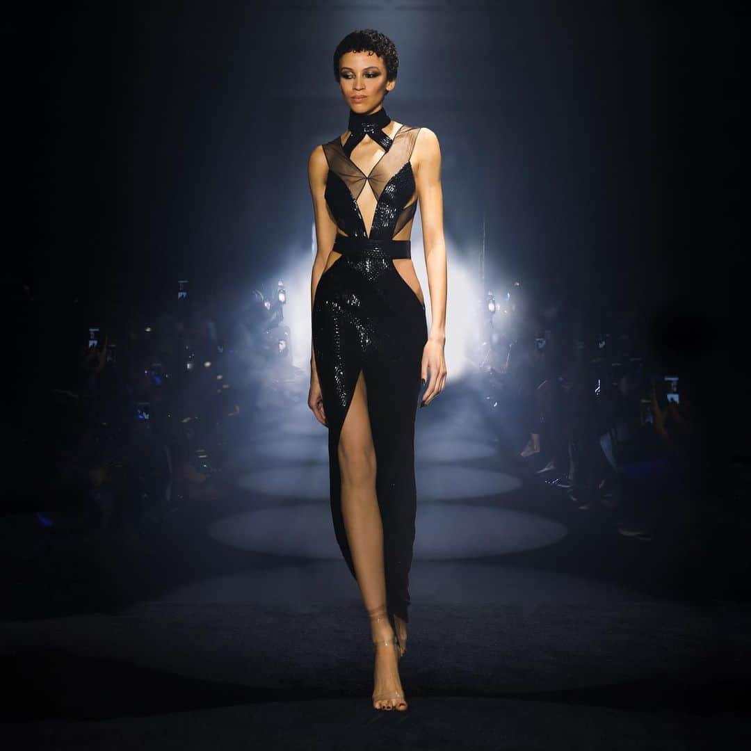 ジュリアンマクドナルドのインスタグラム：「Stepping into the spotlight with an otherworldly charm and elegance, the enchanting @alsoknownasem embodies divine beauty in an Italian stretch crepe couture gown with seductive cutouts, fine mesh strapping, and a high neck, defining the silhouette in a hypnotic and delicately hand-embellished liquid faceted jet black baguette sequin.  Big thank you to all who contributed to a successful JULIENxGABRIELA AW24 show」