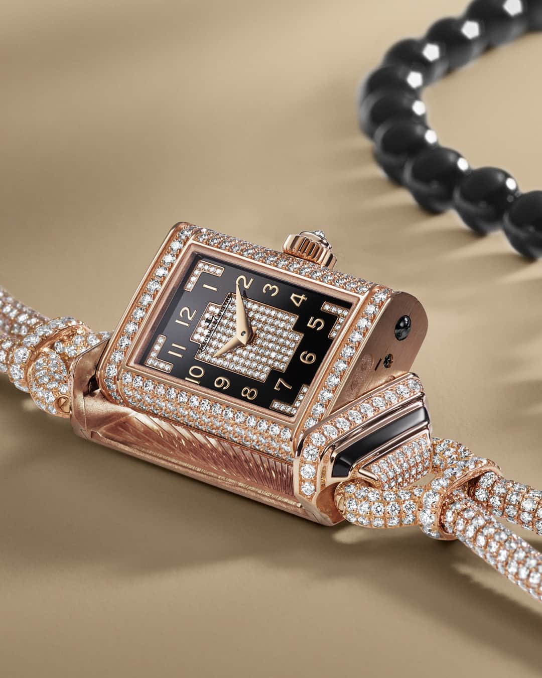 ジャガールクルトのインスタグラム：「Introducing the new Reverso Secret Necklace. #Reverso _ The iconic cordonnet bracelet of the 1930s Reverso models resurges through the new Reverso Secret Necklace. This timeless design has been reimagined as a supple chain, adorned with intricate diamond-set links and polished onyx beads. A Reverso, set with precious stones, is suspended from this radiant chain, allowing savoir-faire to meet timeless elegance.  _ #JaegerLeCoultre #TheGoldenRatio #HighJewellery」