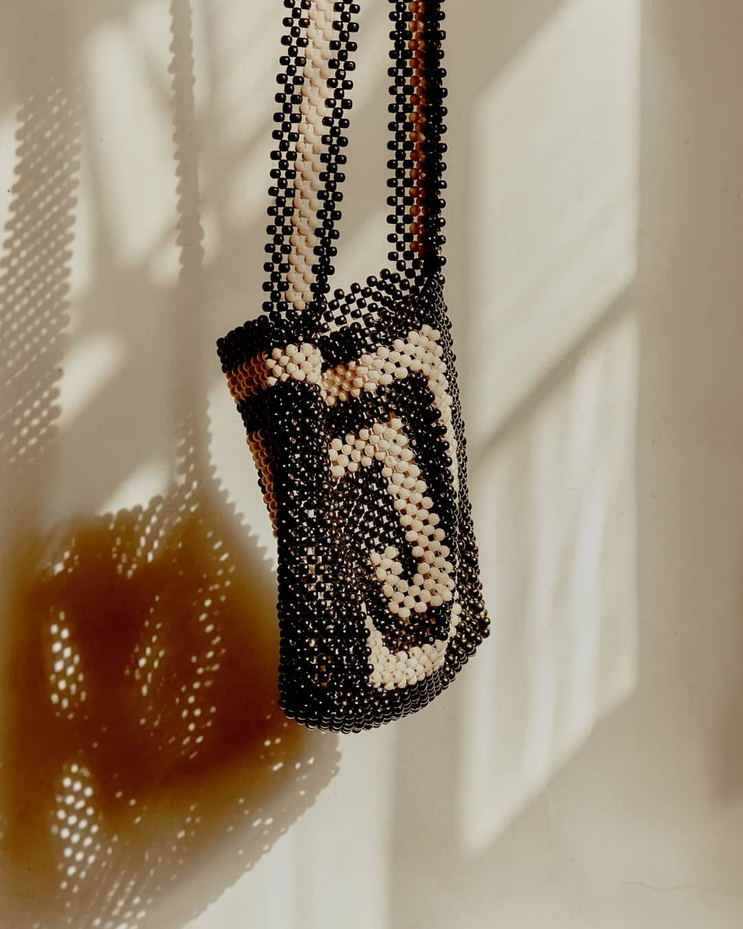 のインスタグラム：「Beaded SS23 Pilgrim shoulder bag with contrasting swirl design.」