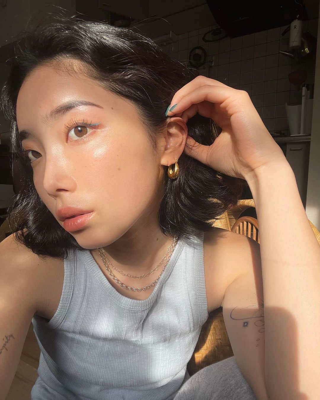 yuikoのインスタグラム：「久々にこんな化粧をした顔を投稿する気がする🙃 最近夏っぽいコスメをたくさんいただいので、そのこたちを使って💫  🍊🫐🤍 face powder @byurjapan  glitter / lipstick @didion_beauty  eyeliner @uzu_byflowfushi   お気に入りのピアスは @cene_316l 🪞」