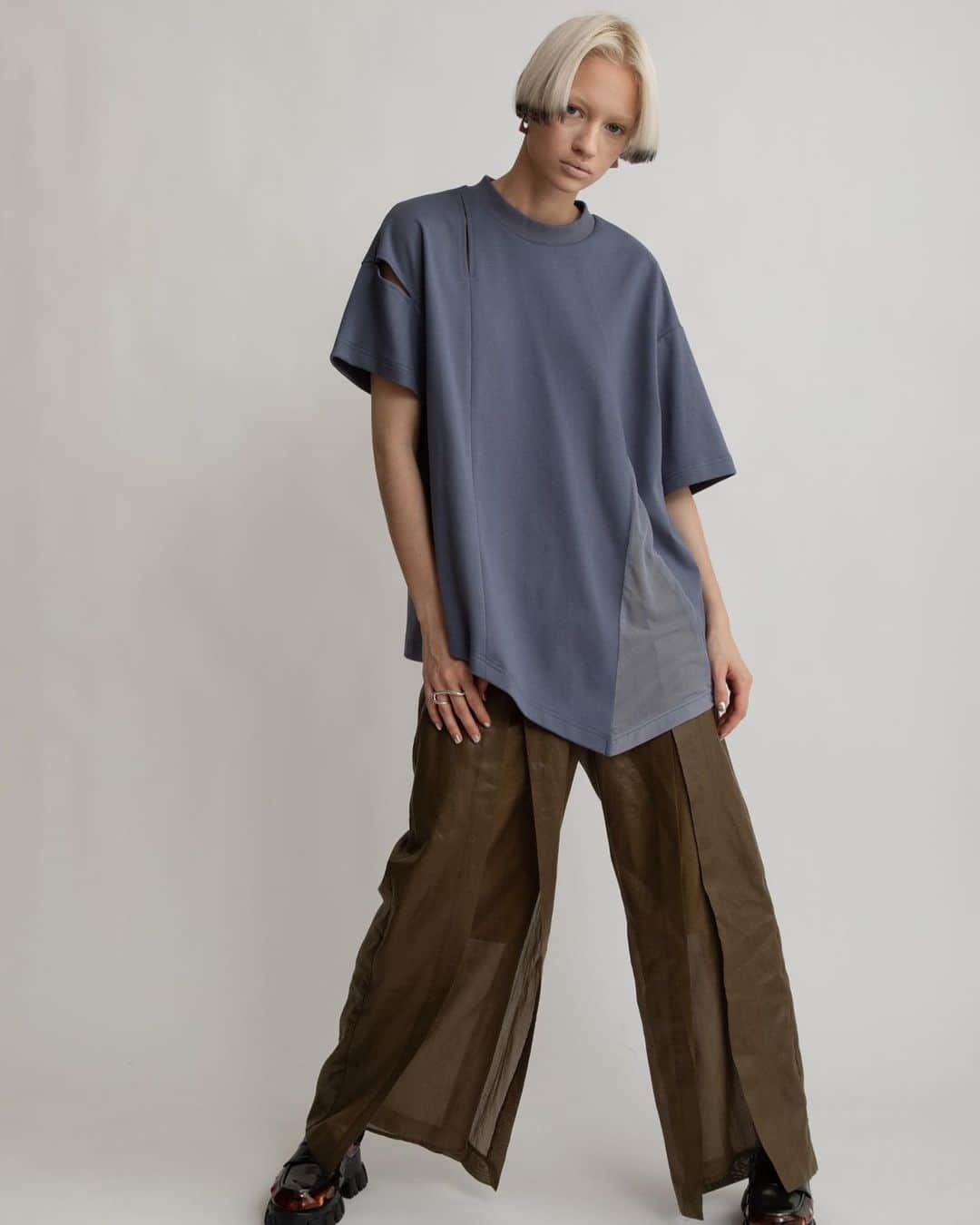 AULA AILAのインスタグラム：「【2023 HIGH SUMMER COLLECTION】  ASYMMETRY LOOSE T-SHIRT COLOR BLUE SIZE 0 ¥13,200  さりげないスリットディテールと、裾にはめ込んだパワーネットのマチがポイント。 袖丈、切り替えライン、ヘムラインなど、アシンメトリーな要素を加えエッジをプラスすることで、シンプルになりすぎず1枚でも存在感あるアイテムに。 素材は、透けにくく適度な厚みがありながら、さらりとした肌触りのコットンスムース素材を使用。 ルーズパンツやスカート合わせなど、リラックス感のあるスタイリングがおすすめ。   SLIT LAYERED PANTS COLOR KHAKI SIZE 0/1 ¥24,200  薄手のレザーのような光沢感と本来のスパンボイルの透け感が相まって、新鮮な印象に。 フロントは大胆なスリットになっていて、内側にパンツがレイヤードされています。 動くとスリットが開くデザインが、軽やかでアクティブ。 穿き心地はリラックス感がありながら、光沢感とデザインによりきれいめな印象なのでTシャツなどラフなアイテムを合わせてもカジュアルになりすぎないアイテムです。 ウエストベルトの後ろのみゴム入りなので、締め付けられないノンストレスです。   ✔️AULA AILA OFFICIAL WEB STOREにて HIGH SUMMER COLLECTIONアイテム展開中！」