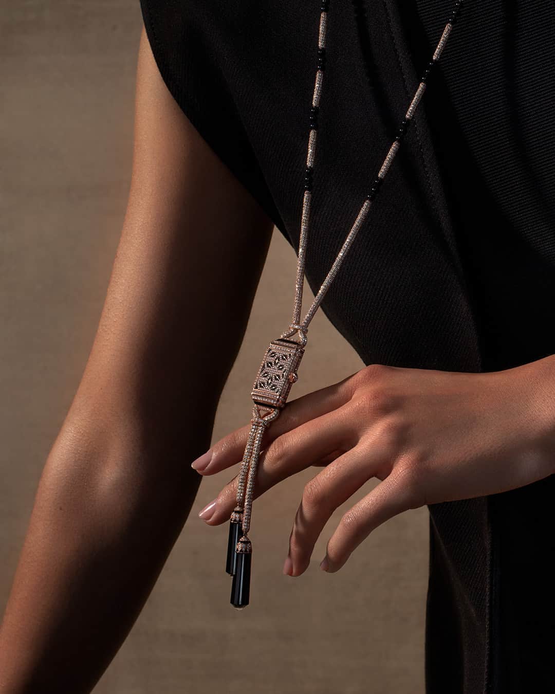 ジャガールクルトのインスタグラム：「Unlock the secrets of time with grace and style.  #Reverso _ Adorned with elegant Art Deco patterns, the Reverso Secret Necklace conceals its secret power of time-telling until the wearer chooses to reveal it. Enhancing its allure, two polished onyx charms delicately dangle, adding a refined flourish to this innovative and elegant approach to wearing time. _ #JaegerLeCoultre #TheGoldenRatio #HighJewellery」