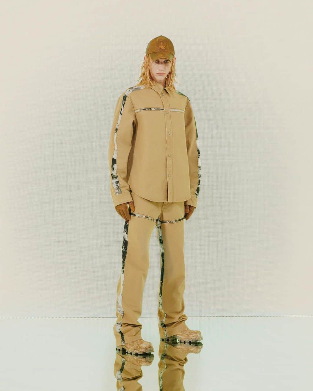 ディーゼルのインスタグラム：「Industrial grade.   A new atmospheric take on camouflage, the Planet Camo print from #DieselFW23 trims a minimalistic khaki workwear shirt and pants and a past T-shirt and matching pants, breaking up monochromatic looks with a graphic attitude.   Discover more at the link in bio.  #ForSuccessfulLiving」