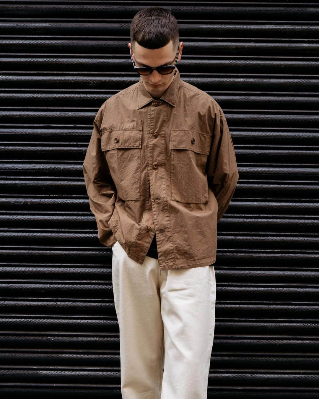 ユーマストクリエイトのインスタグラム：「Jordan in the SS23 Military field shirt, cut in an ultra-fine cotton for a light yet durable fit, then garment dyed and finally rinse washed.  With ecru Tearaway jeans and Allday olive green @bridgesandbrows sunglasses.」