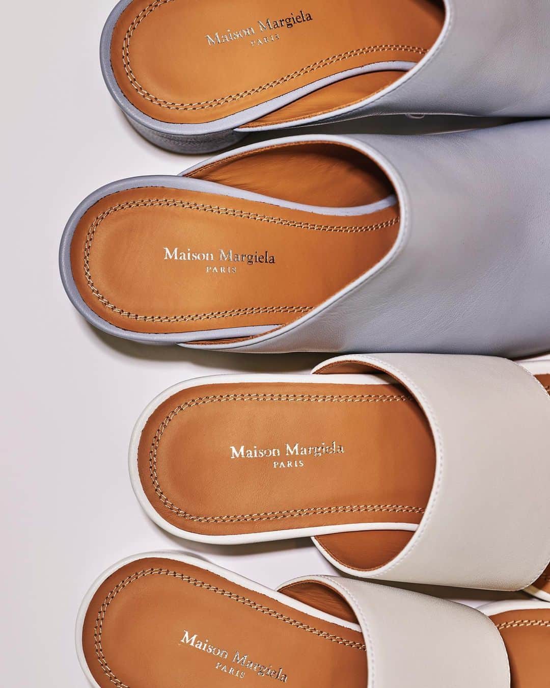 LOVELESS/GUILD PRIME 公式アカウントのインスタグラム：「『 FEATURE 』 SUMMER MUST BUY vol.2 -WOMEN- 夏に向けたバイヤーレコメンドアイテム  【Maison Margiela】SOFT TOUCH LEATHER HANNAH MULES/SOFT TOUCH LEATHER HANNAH MULES low  ブランドを代表する日本の伝統的な足袋から着想を得た「タビ」シューズをピックアップ。ブーツがより有名ではありますが、「タビ」ファンの方は春夏の足元も探されているのではないでしょうか？ 今シーズンラブレスでは7㎝ヒールはシーズンカラーであるPALE BLUE、4cmヒールはWHITEとBLACKをピックアップ。親指ストラップのヌーディなタイプ、甲をすっぽり覆うタイプともに、柔らかなレザーを使用し優しい足当たりがうれしいポイント。いずれもブーツ同様円柱型のモダンなヒールで後ろ姿も素敵にきまります。足を入れてもスプリットトゥのシルエットがクールに見えるのもポイントが高い点です。 Tシャツにデニムになりがちなスタイルに、足元はタビミュール。素足で履くのはもちろん、チュールのソックスと合わせるのも洗練された雰囲気につながります。  Mules(left) ￥121,000 (644-05-158-22) Mules(right) ￥113,300 (644-05-159-01) ※Maison Margielaはラブレス青山のみの取り扱い @loveless_aoyama」