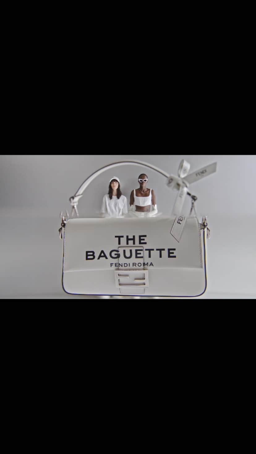 Fendiのインスタグラム：「With a bow on top. The iconic #FendiBaguette is accented with a Fendi Roma ribbon in #MarcJacobsXFendi.  Artistic Director of Couture and Womenswear: @mrkimjones​ Artistic Director of Accessories and Menswear: @silviaventurinifendi ​ Artistic Director of Jewelry: @delfinadelettrez​ Artistic Director: @themarcjacobs   Direction: @johnyuyi  Styling: @elliegracecumming  Hair: @evaniefrausto Makeup: @marcelogutierrez  Casting: @shelleydurkancasting Set Design: @mattjacksonmattjackson Music: @pandorasjukebox  Models: Nyalit Laul, Shelby Smith」