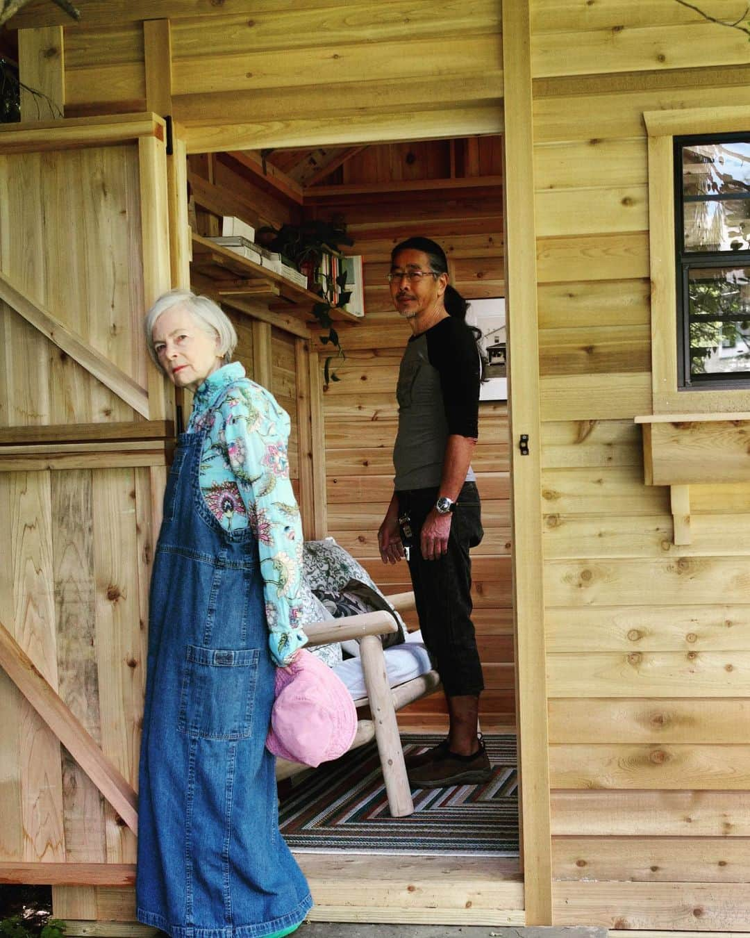 Accidental Iconのインスタグラム：「The Secret Shed.  My favorite book as a child was,”The Secret Garden”. I found such hope in it. A place that had become dormant through neglect triggered by loss could, with a small amount of care, regenerate, recover and be renewed.  To mark the occasion of my 70th birthday next month, Calvin has built me a shed. It feels like a secret because it stands at the far edge of our yard almost hidden underneath the sweeping branches of several different types of trees. Over time as the cedar wood turns grey, it will blend even more effortlessly into the landscape. It lays somewhere between a public and private space.   I’ve always been fascinated with the places where women create. Writers, artists, sewers, craft women of all kinds. I love to see what objects they keep near, how they decorate or not, what hangs on the walls and how close or far from nature these structures seem to be. I try to determine, like the clothes they wear, what their personal spaces may say about them.  I don’t know yet what I will create here. Calvin has provided me with an ample workspace and shelves to contain my little library. At the moment, it holds books about clothing and affect, writing from photographs, herbs and roses, needlecraft and mending. I wonder what I’ll make of them all. How they will co-mingle in my brain to produce new ideas. How they will help me to give expression to my creativity in this new decade of life. In my 60s my blog, clothes and journey into the world of fashion was what I did. It’s time for something that reconfigures, regenerates, and reinvents all the experiences I had during the last decade and makes them right for this one.  So I’ll be sending dispatches from the Secret Shed, will take photos there and share what I think about, write about and what I do there as I head into my next “What Now”  I could not have asked for a better birthday present than this lovingly made and given one by the man who knows me so well. I remain aware of how much privilege is mine. I am grateful.  What’s your creative space like? Even if you just hold it in your mind. #howtobeold #ageisnotavariable #newoldme #shed #nature」