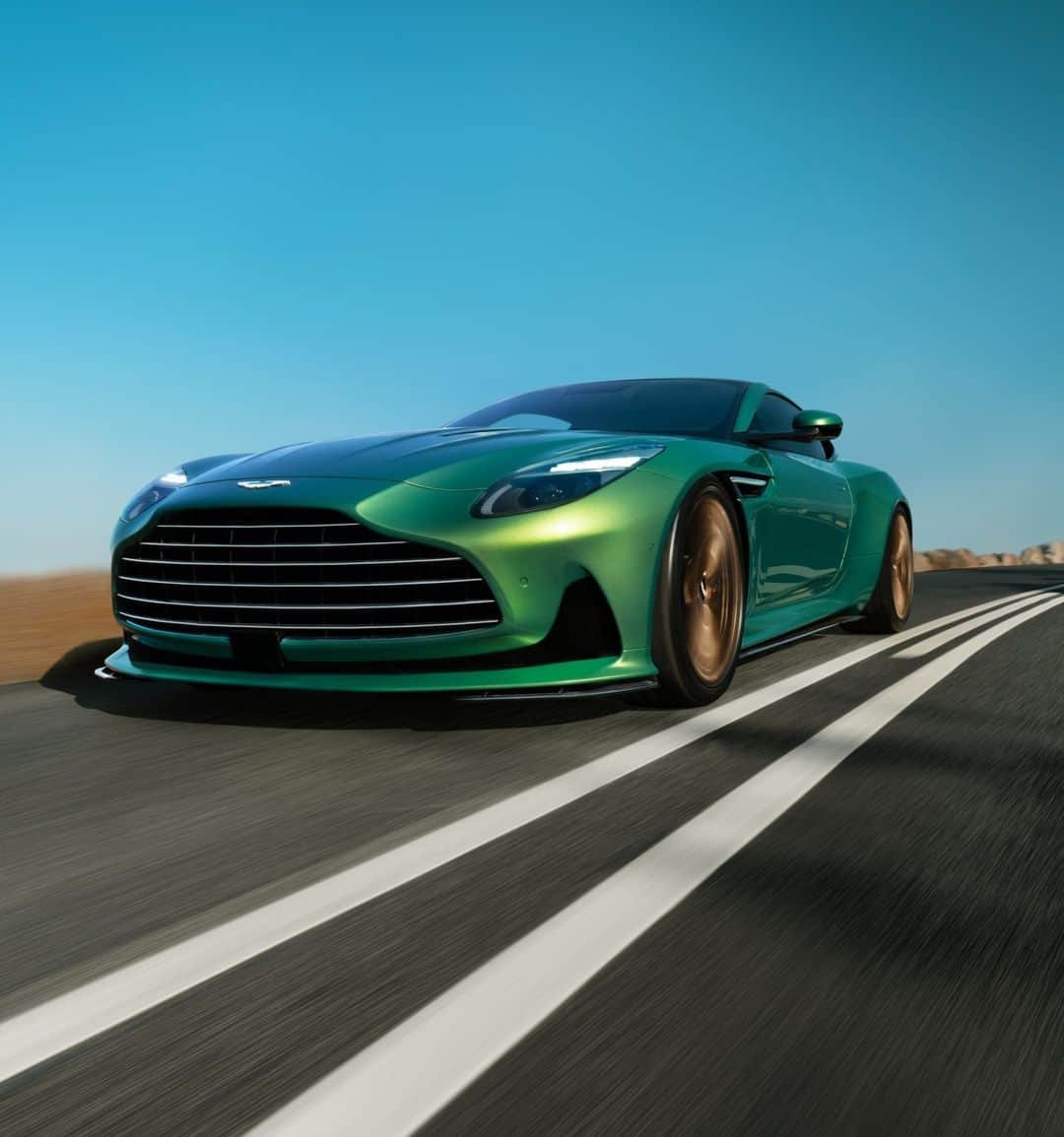 アストンマーチンのインスタグラム：「A new standard of automotive design.  With a wider track and enlarged front grille. Classic elegance meets unapologetic aggression.  #AstonMartin #DB12 #ICONDRIVEN」