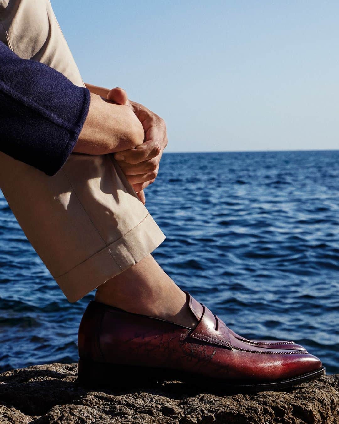ベルルッティのインスタグラム：「- THE SHOE: ANDY BY #BERLUTI -   A true Berluti icon, the Andy loafer was originally designed to be timeless yet unconventional. This season, it takes on a subtle Scritto engraving and a distinctive Terra di Siena seasonal patina, a nod to the Summer 2023 collection’s Riviera inspiration.   Now available online and in-store.  Styling by @virginiebenarroch  Photography by @anthonyseklaoui」