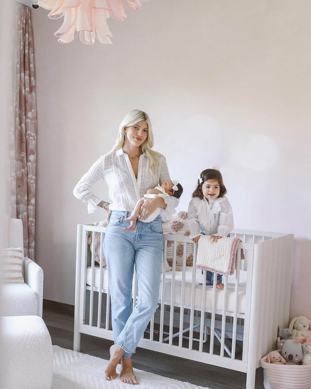 デヴォン・ウィンザーのインスタグラム：「Celine’s nursery! 🩷 We went very tonal for this room with the pastel, rosey-pink, lime wash walls and the weathered wood crib and dresser. I love how delicate and girly her vintage chandelier is and how it looks like a flower ! The cream rug and boucle rocker really lighten up the space! For the curtains we custom picked a fabric that would tie it all together !」