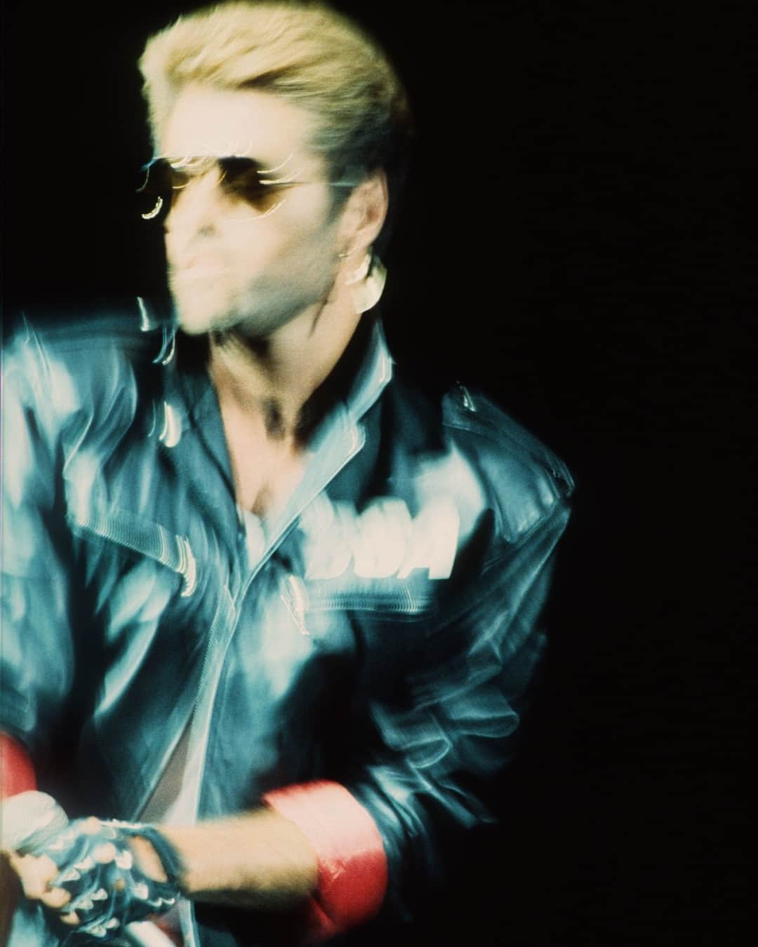 AnOther Magazineのインスタグラム：「George Michael would have been 60 years old today 🤍⁠ ⁠ When the singer burst onto the music scene in 1982, he adopted a leather biker jacket, stonewashed denim jeans and his trademark gold crucifix dangling from his ear as his signature, quickly becoming a global pop star. At the link in bio, we chart the music icon’s sartorial journey and ongoing influence on the world of fashion 📲⁠ ⁠ 📸 by @gieknaeps, courtesy of Getty」