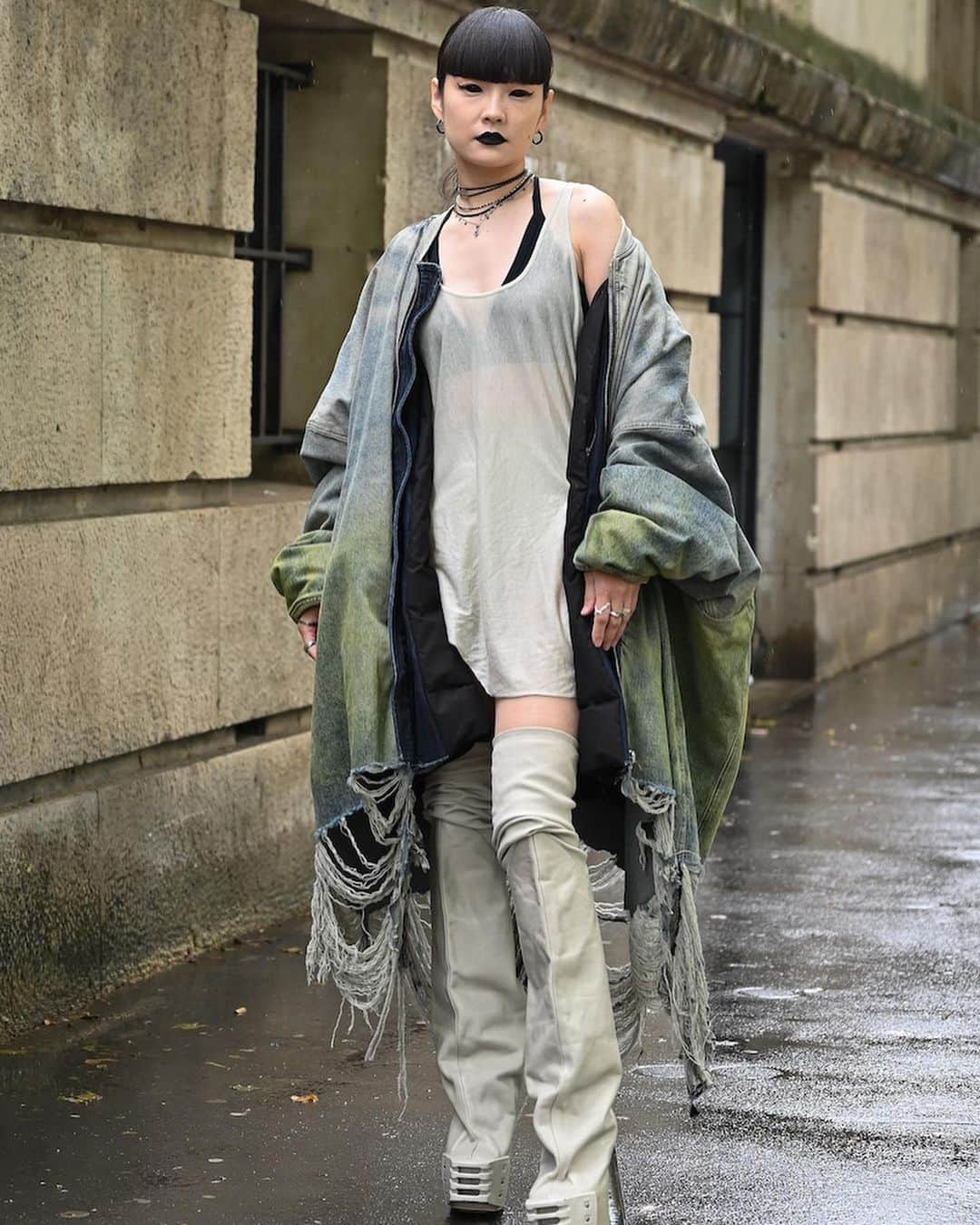 WWDジャパンさんのインスタグラム写真 - (WWDジャパンInstagram)「ファッション・ウイーク・スナップ：引き算を覚え始めた「リック・オウエンス」信者　雨にも負けない暗黒個性の2024年春夏メンズショー来場者  「リック・オウエンス（RICK OWENS）」は、パリ・メンズ・ファッション・ウイークで現地時間6月22日に、2024年春夏メンズ・コレクションを発表した。会場のパレ・ド・トーキョー（Palais de Tokyo）は黒ずくめのリック信者で溢れ返り、ショー前までは激しい雨が降り続いたものの、開演が近づくにつれて徐々に雨は弱まっていった。  来場者は、同ブランドの余分な要素を削ぎ落としたエレガンスを強調する昨今のクリエイションに共鳴して、装いもカットやシルエットを重視している印象だ。素肌にベールを重ねたようなシアー素材のウエアはリック信者にとって定番で、今季は男性のスカートの着用率も上がっている。14.5cmヒールのプラットフォームブーツの人気は安定しており、この日はラバー素材のレインブーツ風のシューズで雨仕様の足元も見られた。日本からは、モデルの秋元梢と高橋ララらが来場した。  全画像は @wwd_jp プロフィールのリンクから  PHOTO：KOJI HIRANO  #RICKOWENS#リックオウエンス#RICKOWENSSS24#pfw#fashionweek#parisfashionweek#fashion#fashioncollection#パリコレクション#ファッションショー#メンズコレクション#wwdjapanメンズコレ取材#fashionphotographer#fashionsnap#snap#ファッション#ファッションスナップ#palaisdetokyo」6月26日 11時44分 - wwd_jp