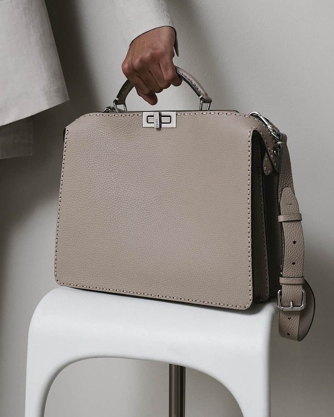 Fendiのインスタグラム：「Forever iconic. The timeless codes of the #FendiPeekaboo complement relaxed suiting silhouettes for #FendiSummer.  Artistic Director of Accessories and Menswear: @silviaventurinifendi ​ Artistic Director of Jewelry: @delfinadelettrez​  Photography: @brunostaub   Styling: @ganio Makeup: @samiamohsein Hair: @ramoneyluv  Casting: @piergiorgio  Model: Abas Abdirazaq」