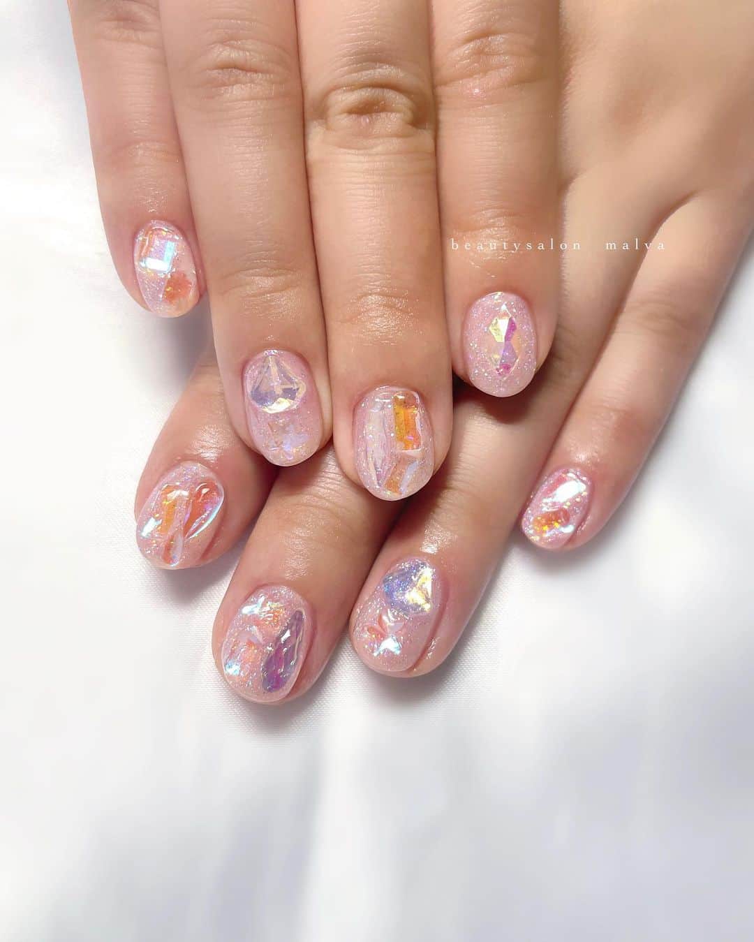 nailsalon malva（ネイルサロンマルヴァ）のインスタグラム：「【キラキラアート092】でご予約可能🉑 暗いところでもキラキラと輝くストーンが人気です😊　 ⁡ 短い爪にもしっかりとストーンのりますし、 生活しても取れないコーティングをするので 安心して手元使えます✨ ⁡ パーツ取れたくない方はmalvaにぜひ🔥 ⁡ ＿＿＿＿＿＿＿＿＿＿＿＿＿ ⁡ ⁡ 𝐛𝐞𝐚𝐮𝐭𝐲𝐬𝐚𝐥𝐨𝐧 𝐦𝐚𝐥𝐯𝐚⠀ 📍明治神宮前駅｜原宿駅　徒歩𝟑分 ⠀ 💬ご予約やお問い合わせ 𝐋𝐈𝐍𝐄から承っております @ 𝐦𝐚𝐥𝐯𝐚 ⁡ お気軽にご連絡ください♡ ⁡ ⁡ ＿＿＿＿＿＿＿＿＿＿＿＿＿＿ ⁡ ▸ジェルネイル｜スカルプ｜ケア ▸まつげカール｜まつげエクステ ▸ハーブよもぎ蒸し ▸ワックス脱毛 ⁡ ⁡ \ アシスタント募集中💁‍♀️ / ⁡ ▸リモート可オンラインの画像動画制作アシスタント ▸サロンワーク全般アシスタント ⁡ ⁡ ⁡ ⁡ ⁡ ⁡  #アイスストーンネイル #偏光ストーンネイル #アイスネイル #malva #malvaネイル #キラキラネイル #氷ネイル #ショートネイル  #nails #原宿ネイル #夏ネイル  #表参道ネイル #東京ネイルサロン　#明治神宮前ネイル #新宿ネイル #千駄ヶ谷ネイル #池袋ネイル #harajukunails #tokyonails #tokyonailsalon ⁡」