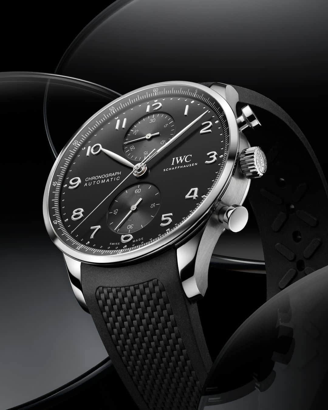 IWCのインスタグラム：「Clear and functional. Our Portugieser Chronograph with its classic 41mm black dial encased in a stainless steel case and accompanied by a black rubber strap.  #IWCportugieser | #TheReference   🔗Link in Bio  ℹ Black dial Stainless steel case 41mm IWC-manufactured 69355 Calibre Ref. IW371609 -  Visit your IWC boutique or retailer to discover the variety of strap options available.」
