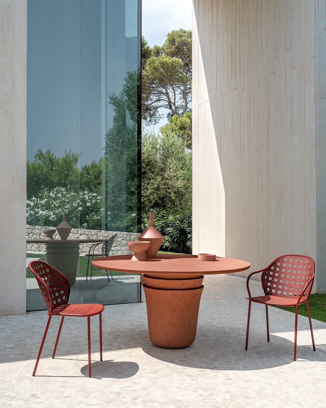 ジェルバゾーニのインスタグラム：「Kasane Collection / a modern patio retreat cherished by the Mediterranean breeze.⁠ ⁠ Modern design meets eclectic charm in this patio for summer evenings. The Kasane collection by @nendo_official takes center stage with its sculptural table, while the Brise chairs by @federicabiasistudio add a touch of elegance with the perforated texture of the back in reference to the straw of Vienna.⁠ ⁠ Styling @ilariabacciocchi⁠ Photo @andreagaruti ⁠ ⁠ ⁠#gervasoni1882 #nendodesign #outdoorliving #GervasoniOutdoor #outdoordesign #outdoortable #outdoorfurniture」