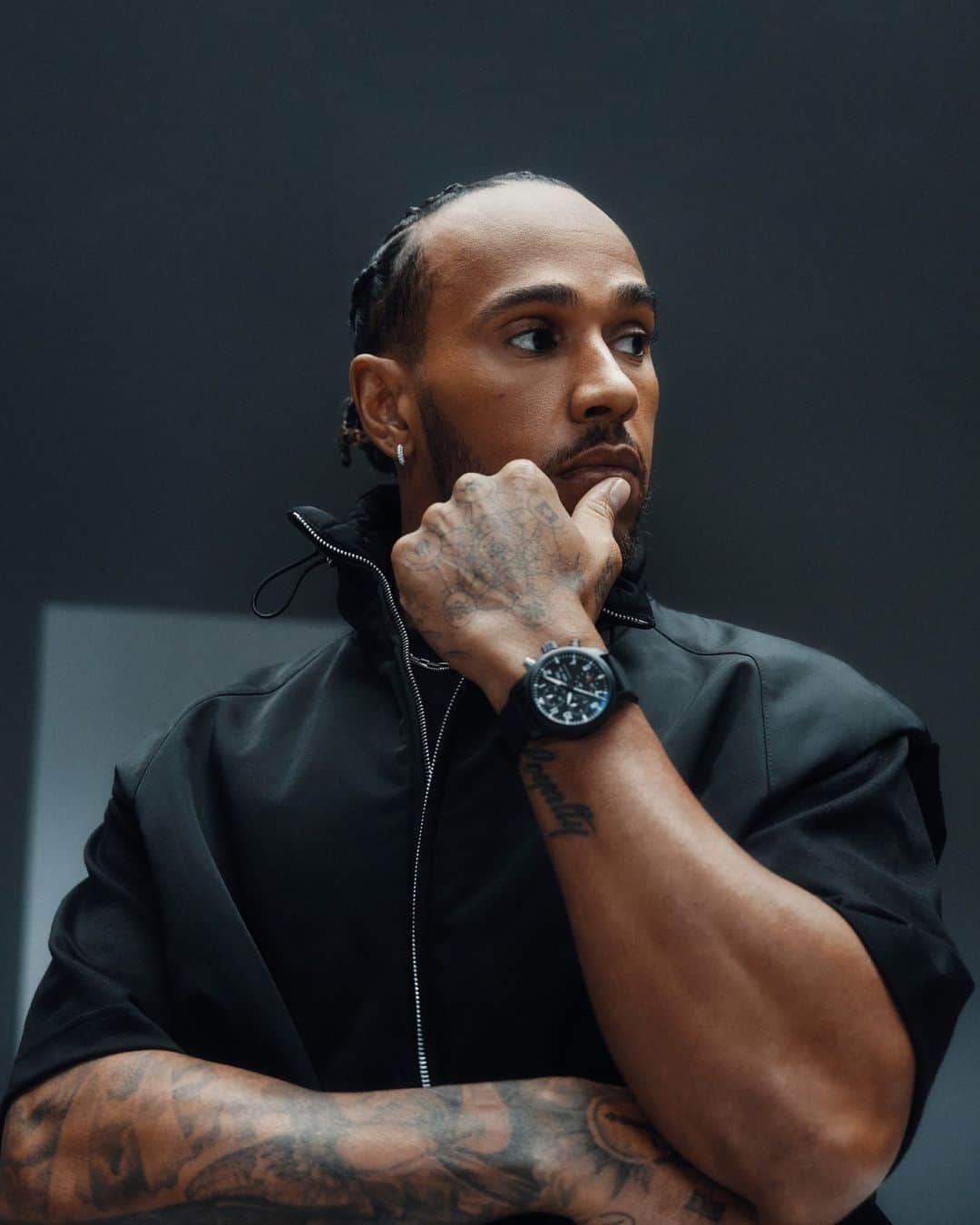 IWCのインスタグラム：「Status symbol. Prized by elite naval aviators, IWC Top Gun watches such as the #IWCpilot Chronograph 41 TOP GUN (Ref. IW389401) worn by @lewishamilton in our signature Jet Black colour, are designed for precision and performance. #TheReference  🔗Link in Bio」
