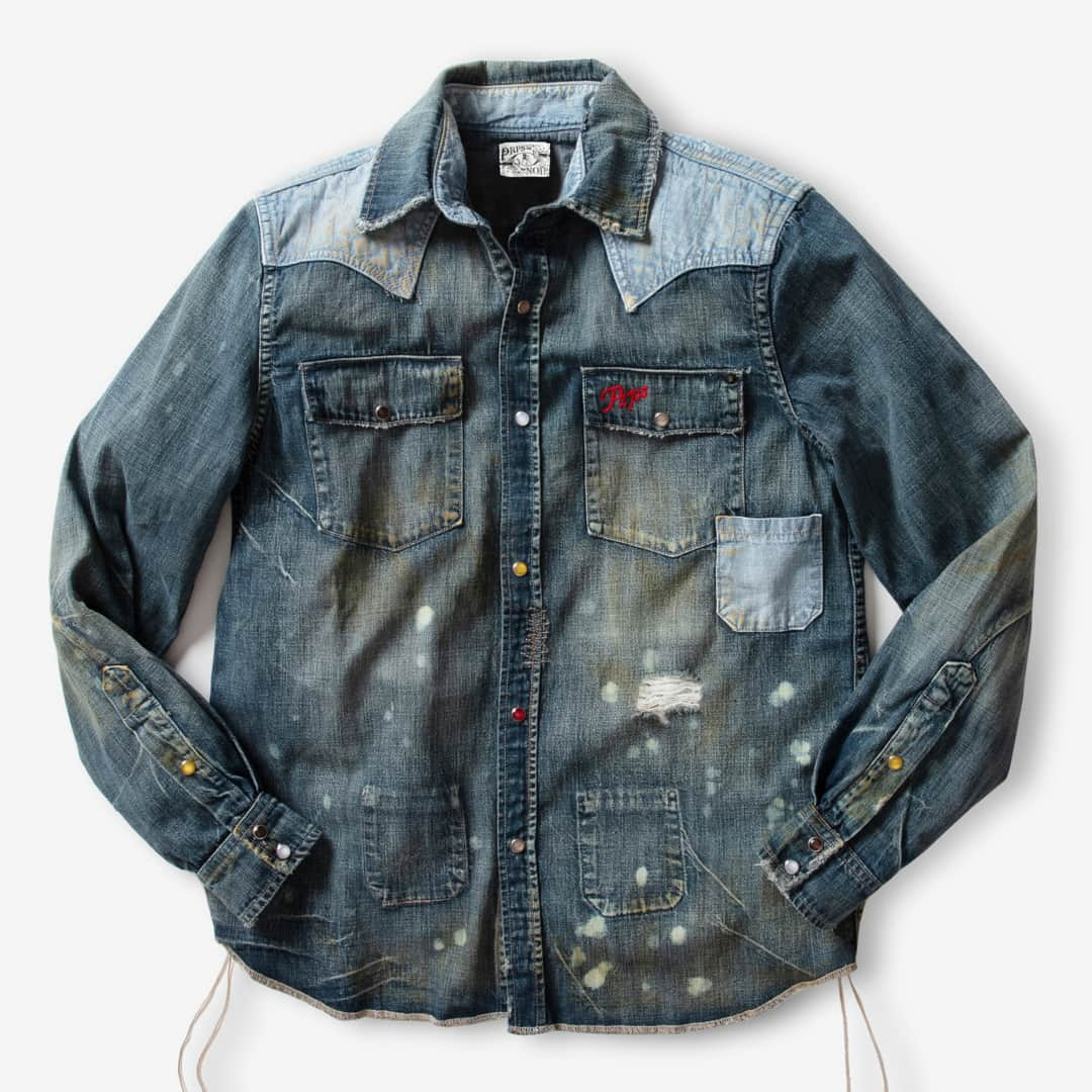 ピーアールーピーエスのインスタグラム：「PRPS NOIR| Sensoji Snap Front Denim Shirt is made from a lightweight Japanese fabric and features a medium wash, tinting, hand sanding and bleach spots. With a multicolored snap front, a contrast, bleached out denim yoke and unfinished hem, this shirt is everything NOIR.」