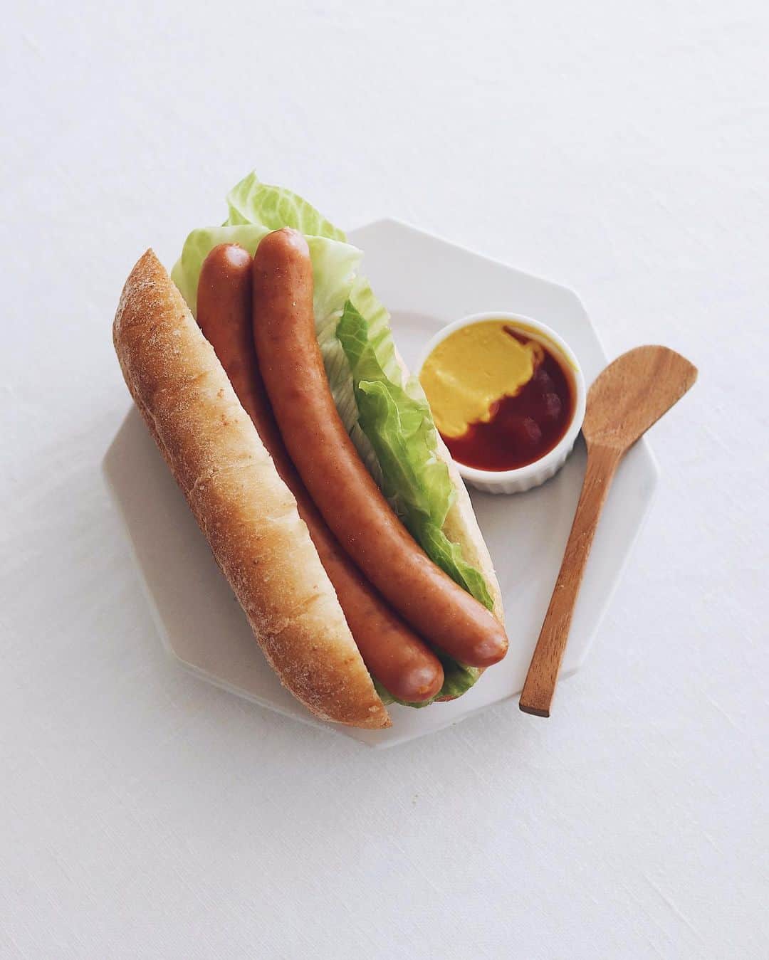 樋口正樹のインスタグラム：「Lettuce hot dog 🌭 . 今朝の朝食はレタスドッグ。 タカキベーカリーのお勧め カスクートフランスを使い、 ロングなウインナー２本と レタスのシンプルですけど ちょっと贅沢な組み合わせ🤗 . @takaki_bakery_official . . . #レタスドッグ #ホットドッグ #カスクートフランス #タカキベーカリー #石窯パン #takakibakery #HotDog #lettucedog #cassecroute #🌭」