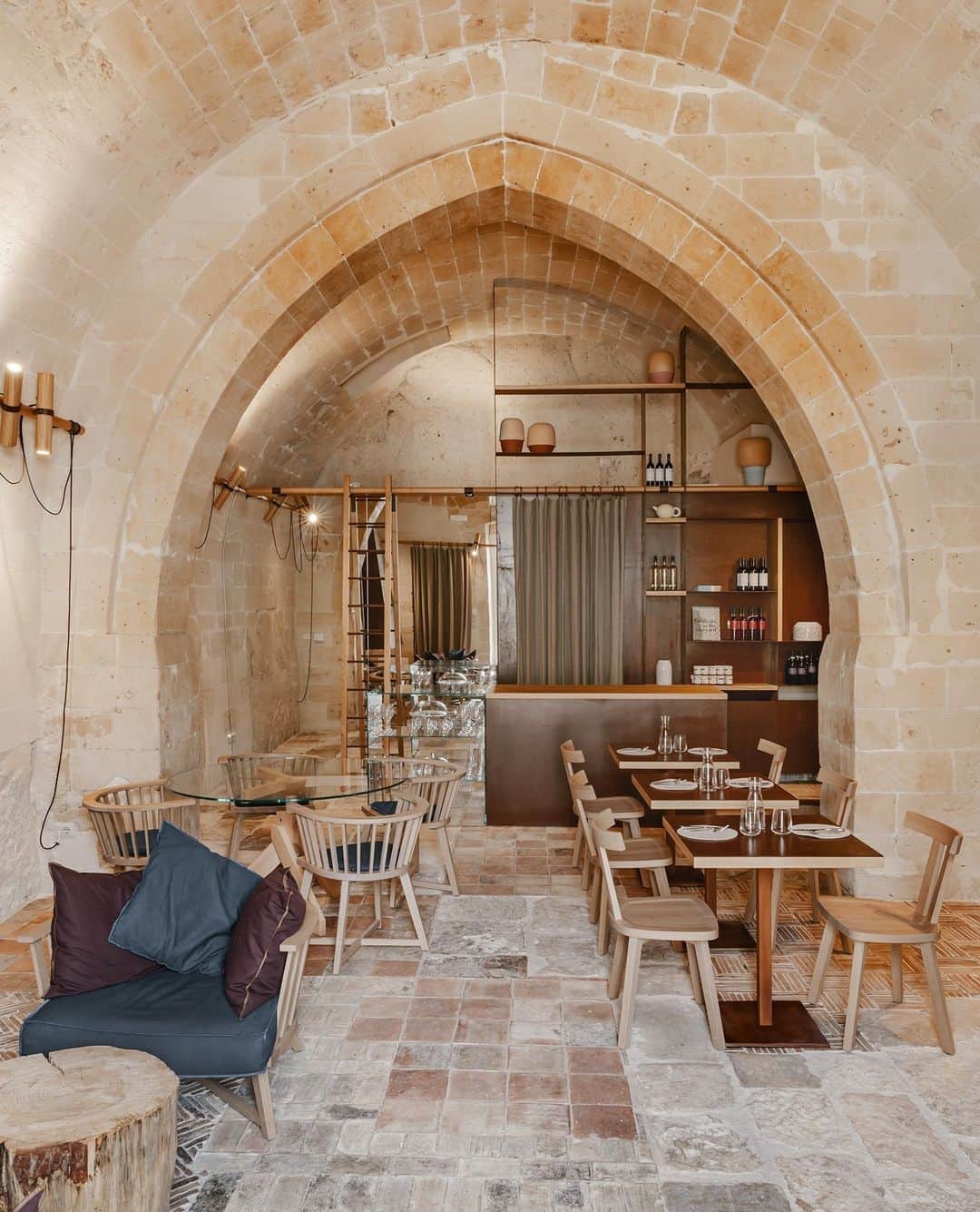 のインスタグラム：「#GervasonINtour⁠ The breakfast lounge of Le Dimore dell'Idris hotel (@le_dimore_dell_idris) overlooks the ancient city of Matera, nestled within the majestic rocky spur that dominates the Sasso Caveoso, at the foot of the Madonna de Idris rock church.⁠ ⁠ While enhancing the interior space, the original material form remains untouched, showcasing the architectural elements crafted from blocks of tuff and carved rock.⁠ A thoughtful chromatic selection of simple and traditional materials like wood, stone, corten steel, and fabrics has been chosen to harmonize the internal and external spaces.⁠ ⁠ The furnishings from our Gray chairs collection by @paola.navone effortlessly harmonize with the project's vision, preserving the serene color palette and seamlessly blending modern and traditional elements.⁠ ⁠ Photo @pierangelo_laterza⁠ Project by @mancastudio⁠」