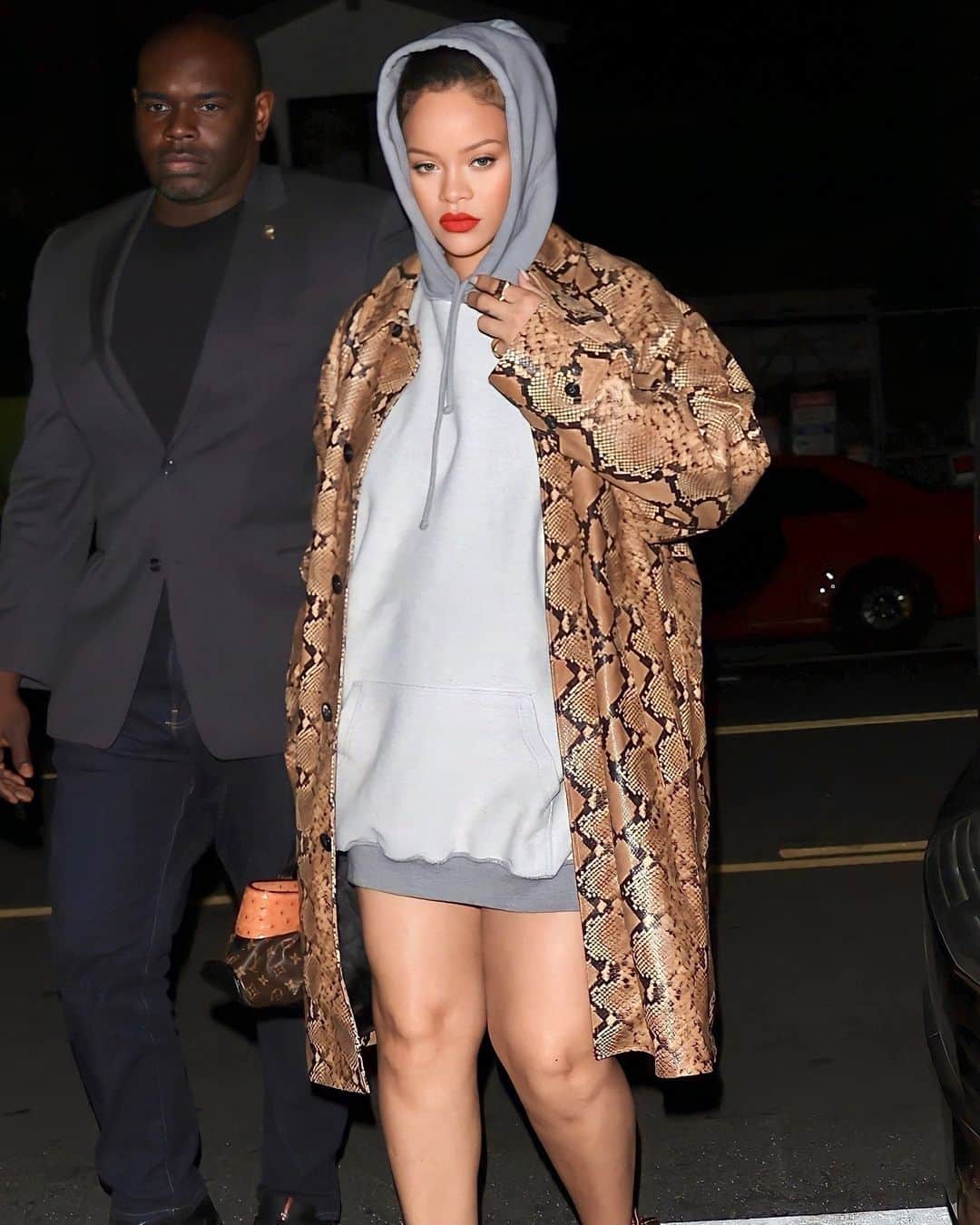 Harper's BAZAARさんのインスタグラム写真 - (Harper's BAZAARInstagram)「@badgalriri looked flawless during a recent night out in LA, where the superstar embraced the no-pants trend in a luxe snakeskin-print coat and a two-tone gray hoodie worn as a minidress. She completed the look with matching printed sandals and @louisvuitton bag.」6月12日 0時55分 - harpersbazaarus
