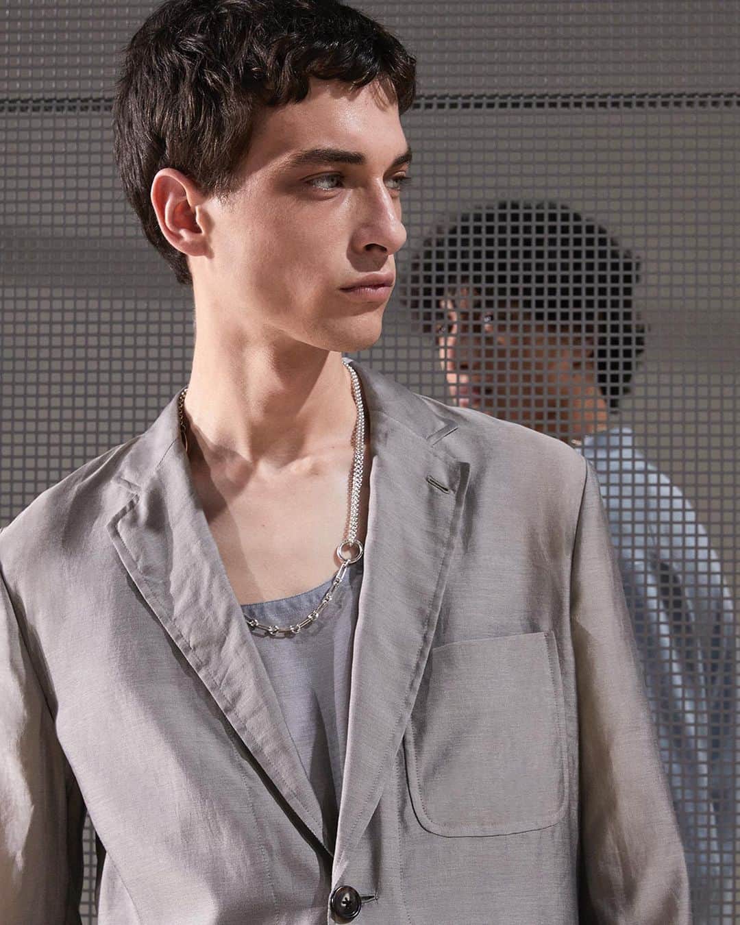 エルメスのインスタグラム：「Heavy silk for summer nights. A collection soft and sweet as a summer breeze, stirred by a tender strength. Clothing as architecture. The look is constructed with the weightlessness of daylight, of openwork.​  About the looks:​ 1- A jacket and a tank top in silk and cotton ‘tracing paper’ fabric. A Chaîne d’ancre Punk necklace in silver. ​ 2- A long-sleeve polo shirt in heavy silk. Trousers in linen and cotton. A belt with a buckle in palladium-finish metal. A Croisette necklace in silver. ​  Men’s summer 2024 runway show, collection created by Véronique Nichanian. ​​ Watch the replay of the show with the link in bio. ​​​  #Summer2024​ #ParisFashionWeek​ #PFW​ #HermesHomme​ #Hermes」