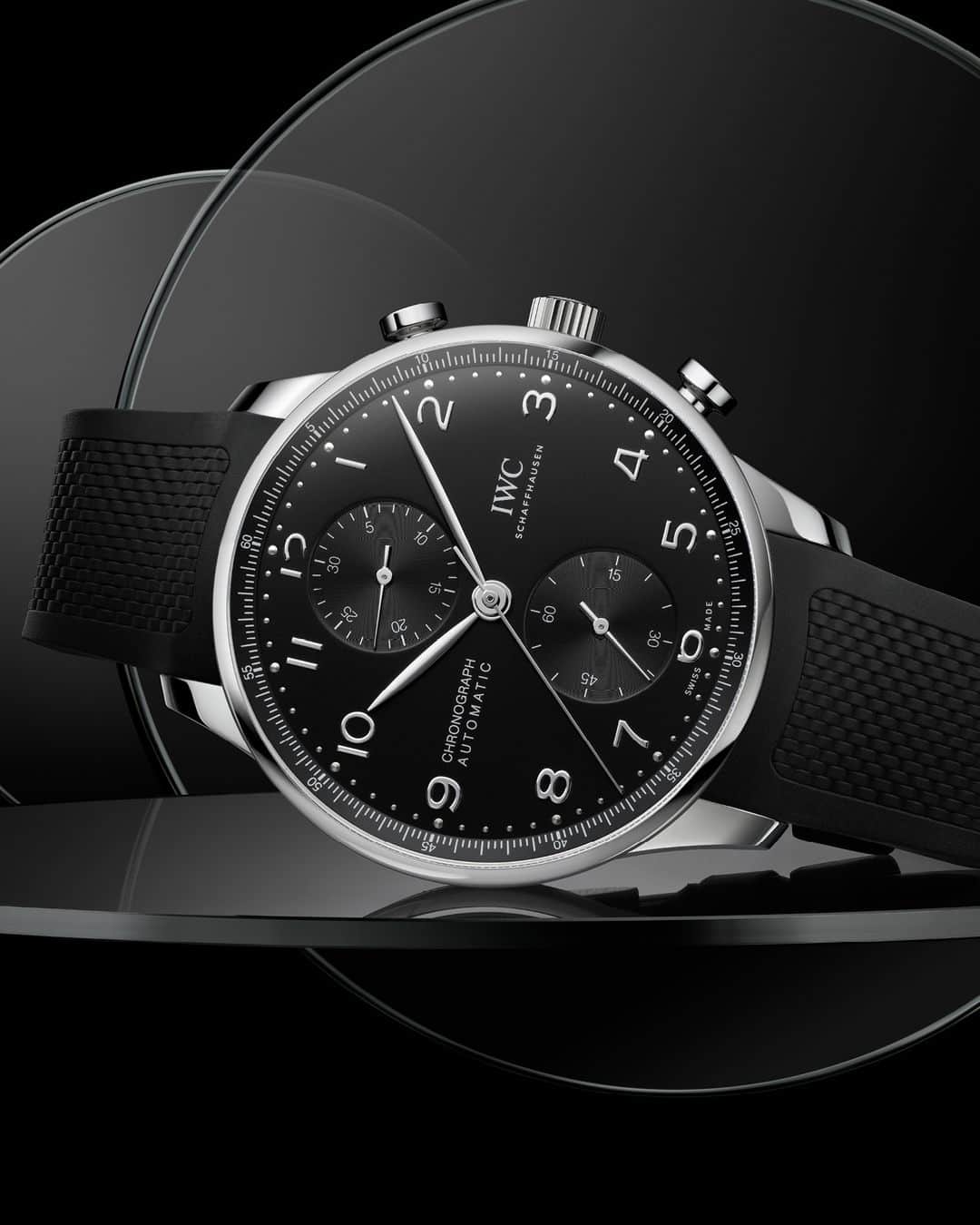 IWCのインスタグラム：「Since 1998. This Portugieser model features a stainless steel case, a black dial, as well as rhodium-plated hands and appliqués; it is fitted with a black rubber strap.   #IWCportugieser | #TheReference   🔗Link in Bio  Ref. IW371609 - Visit your IWC boutique or retailer to discover the variety of strap options available.」