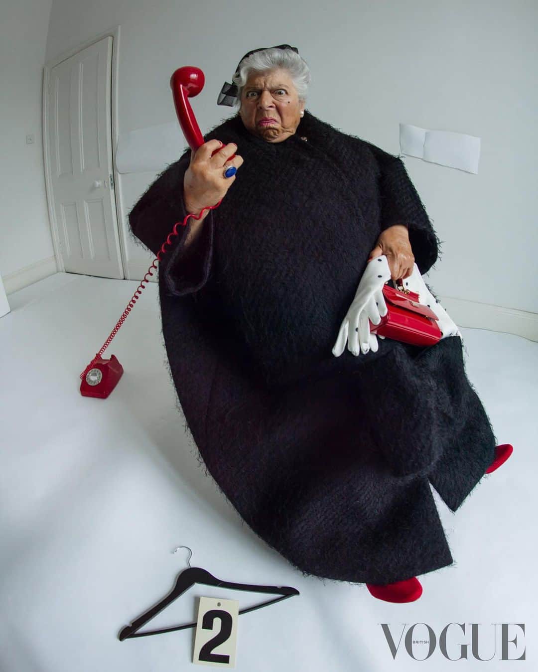 British Vogueさんのインスタグラム写真 - (British VogueInstagram)「“I’m still a bit of a child,” says Miriam Margolyes. “I can’t resist naughtiness.” In #BritishVogue’s July 2023 issue, the actor is at her very best – cheeky, wonderfully candid, and an absolute breath of fresh air. Click the link in bio to read the profile in full, and see the full story in the new issue, on newsstands Tuesday 20 June.  #MiriamMargolyes photographed by #TimWalker and styled by @KPhelan123, with hair by @AliPirzadeh, make-up by @BeaSweetBeauty, nails by @Simmy_NailsAndBeauty, set design by @MigsBento and production by @Zoe_Wassall at @GreatSouthernProductions, with thanks to @GeorgeN49.  [Image Description: Image one shows Miriam Margolyes, a white woman with silver hair sitting down at a table covered in white doily lace in an all-white room. She is shown from the waist up, and is naked except for pearl earrings, a pearl necklace and a blue cocktail ring. She is also wearing red nail varnish, a dark pink lipstick and has a small beauty spot drawn under the outer edge of her left eye. She is looking into the camera and smiling. In front of her sit two clear cake stands which hold piles of cherry Bakewell tarts, which cover her nipples. In between the stands is a floral saucer and teacup, with a small amount of tea inside.  Image two shows Miriam Margolyes, a white woman with silver hair, sitting in an all-white room. She is wearing a black headband, gold and pearl earrings, and a black coat. She has pink lipstick on, and is smiling into the camera.  Image three shows Miriam Margolyes, a white woman with silver hair standing in an all-white room. She is wearing a long black dress, a blue coat, a blue cocktail ring, pearl earrings, a pearl necklace, and red shoes which match her red nail varnish and red lipstick. She is looking just off camera and smiling, and in her right hand is a card with the number “3” on it. On the floor to her right is a black hanger, a red hat, red shoes, a black hat with a white bow, a houndstooth coat and cards with the numbers “1”, “7” and “9” on it.  Continued in pinned comments.]」6月14日 0時15分 - britishvogue