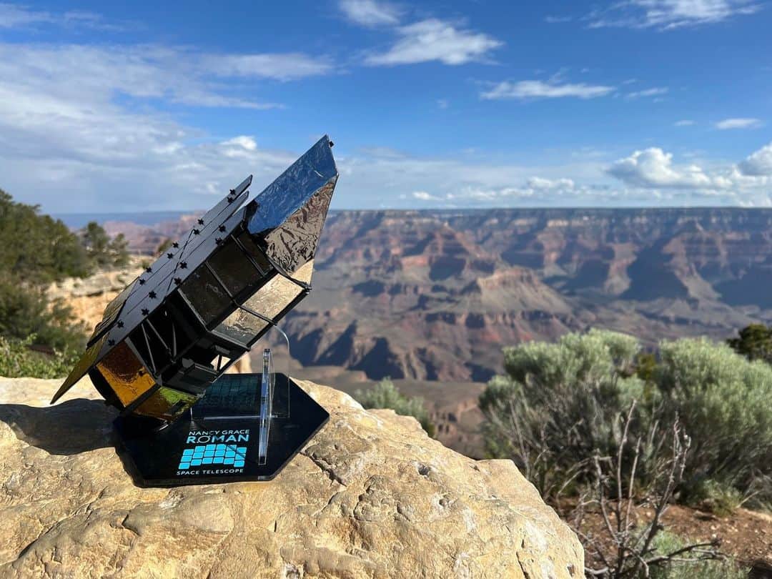 NASAさんのインスタグラム写真 - (NASAInstagram)「Sooo much room for our model of NASA's Nancy Grace Roman Space Telescope to stretch its antenna! 📡🏔️ Thank you, @GrandCanyonNPS, for inviting us to your Dark Sky Party! We can't wait to map the dark expanse of the universe!!  Image Descriptions: 1: Mini 1/80th scale model of the Nancy Grace Roman Space telescope sitting on top of a rock in the foreground. The telescope is cylindrical with rectangle-shaped solar panels on the back of it. There is a gold foil wrapped on the lower half of the telescope and a duckbill-shaped sun shield on the top of the telescope that is silver in color.   The telescope is attached to a black base with the telescope's name printed in blue and 18 squares representing the telescope detectors. The location in the background is the Grand Canyon; the sky is blue with sparse clouds. Green shrubbery is on the left and right sides, with some bare branches scattered throughout.   2: An audience is sitting outside in the Grand Canyon at night, watching a woman give a presentation; she is standing next to a podium. Light is coming from the presentation on the right side of the image. The sky is dark blue, with a silhouette of trees in the foreground.」6月15日 0時56分 - nasagoddard