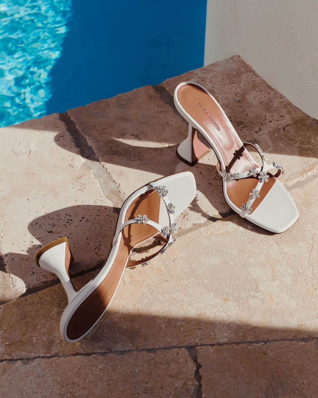 barneysnyofficialのインスタグラム：「Elevated by a signature pyramid heel, Amina Muaddi’s Lily sandals are finished with a square, open toe and crisscross straps. @aminamuaddiofficial」