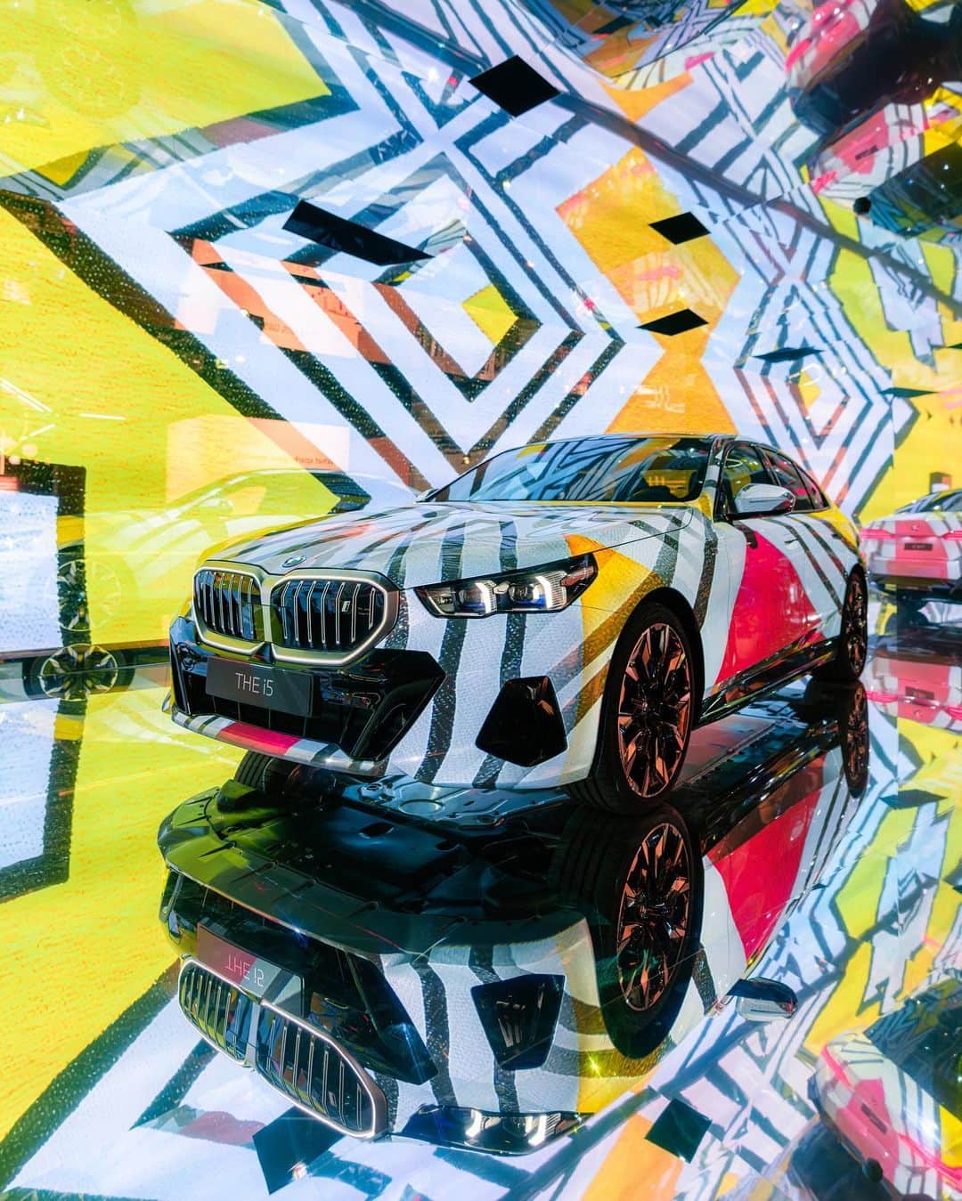 BMWのインスタグラム：「When art meets technology. In collaboration with @nathan_shipley_vfx and @artdrunk and five contemporary artists, we created The Electric AI Canvas transforming THE NEW i5 into an ever-changing art experience at @Artbasel.   @ArtBasel #ArtBasel2023 @bmwgroupculture 📷 @mikenimtsch   Meet our five artists: @EstherMahlanguArt, @Nawa_Kohei, @Ernatmack, @jynsjunup, and Bin Woo Hyuk  THE NEW i5. 100% Electric. #THENEWi5 #THEi5 #BMW #BMWi #BornElectric #BMWElectric __ BMW i5 eDrive40*: Combined power consumption: 18.9–15.9 kWh/100 km. Combined CO2 emissions: 0 g/km. Electric range: 497–582 kilometers. All data according to WLTP. * Preliminary data; no homologation figures available yet. Further info: www.bmw.com/disclaimer」