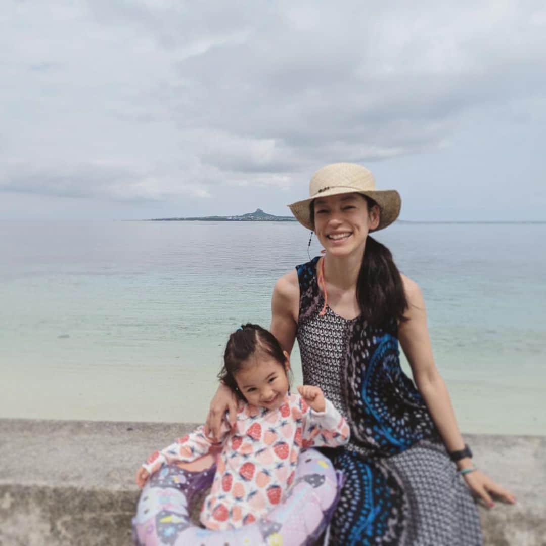 のインスタグラム：「沖縄で娘と👧🏻🌈  向こうに見えているのは伊江島で 真ん中にちょんと飛び出ているのは城山タッチュー フェリーで島に渡ったときに娘と一緒に登ってきた 駐車場から登り階段およそ10分の道のりで360度の景色✨」