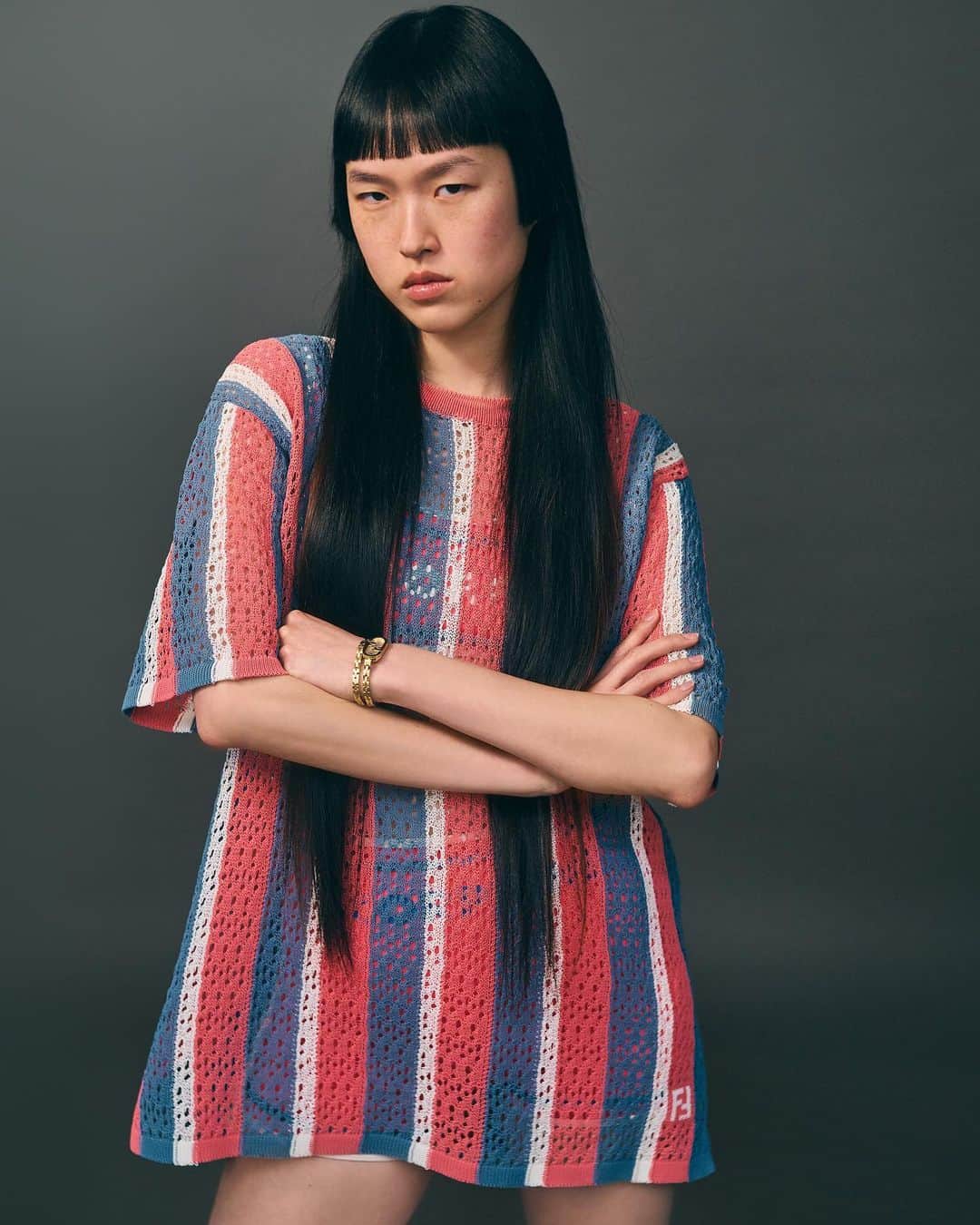 Fendiのインスタグラム：「An airy crochet top in the season's key colourway is accented with a subtle FF intarsia in the #FendiSummer edit.  Artistic Director of Couture and Womenswear: @mrkimjones​ Artistic Director of Accessories and Menswear: @silviaventurinifendi ​ Artistic Director of Jewelry: @delfinadelettrez​  Photography: @collierschorrstudio  Styling: @elliegracecumming Hair: @evaniefrausto Makeup: @dickpageface Set Design: @javirigoyen  Casting: @nicola.kast   Model: Hody Yim」
