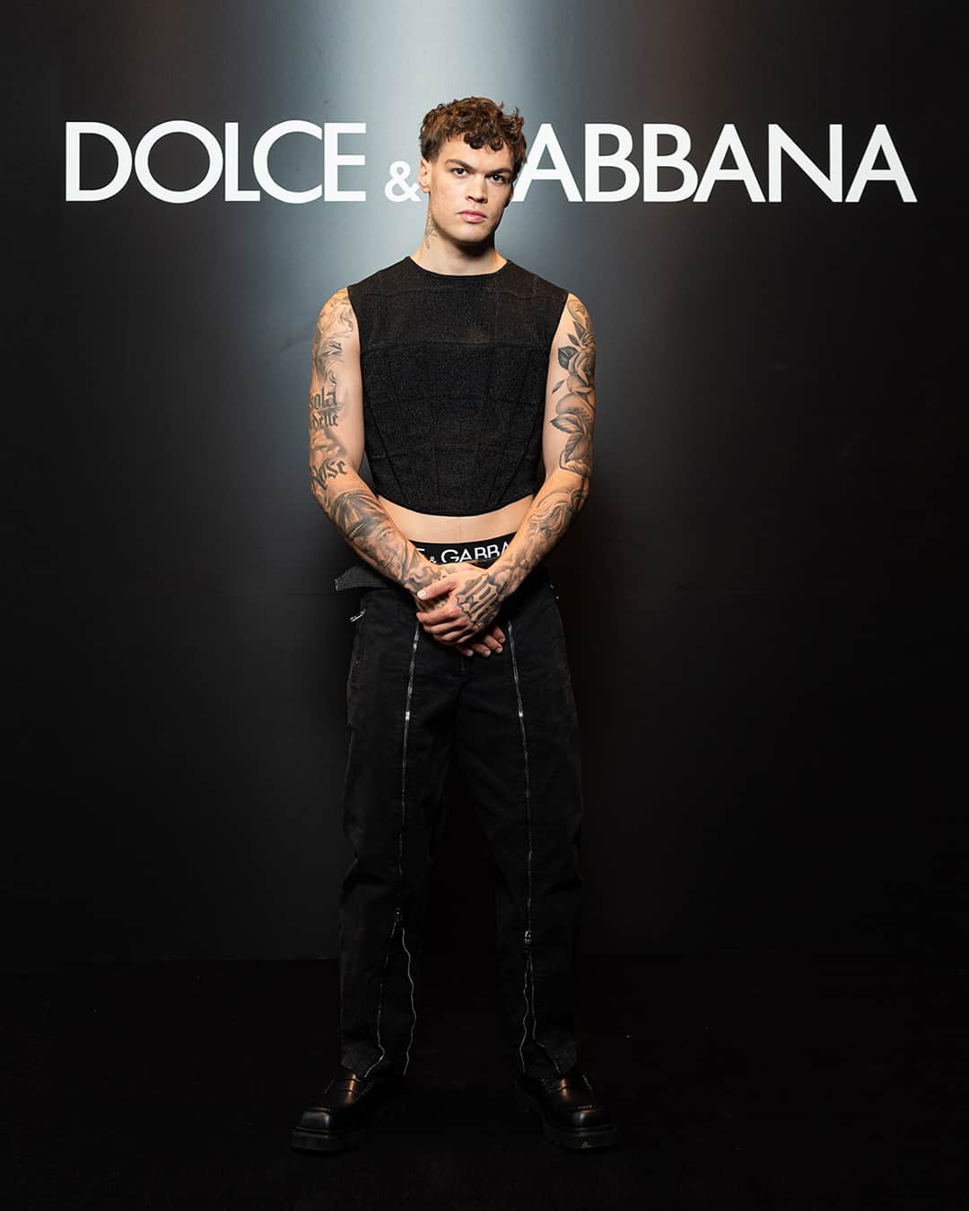 のインスタグラム：「Wearing total #DolceGabbana looks in attendance of the #DGSS24 Men’s Fashion Show “Stile” were @blanchitobebe and @dissgacha.    Blanco wore a black knitted corsetry top styled with a pair of zipped up cargos, with logo underwear and black square toe derby shoes.    Diss Gacha wears a #DolceGabbana total look.    #DGCelebs」