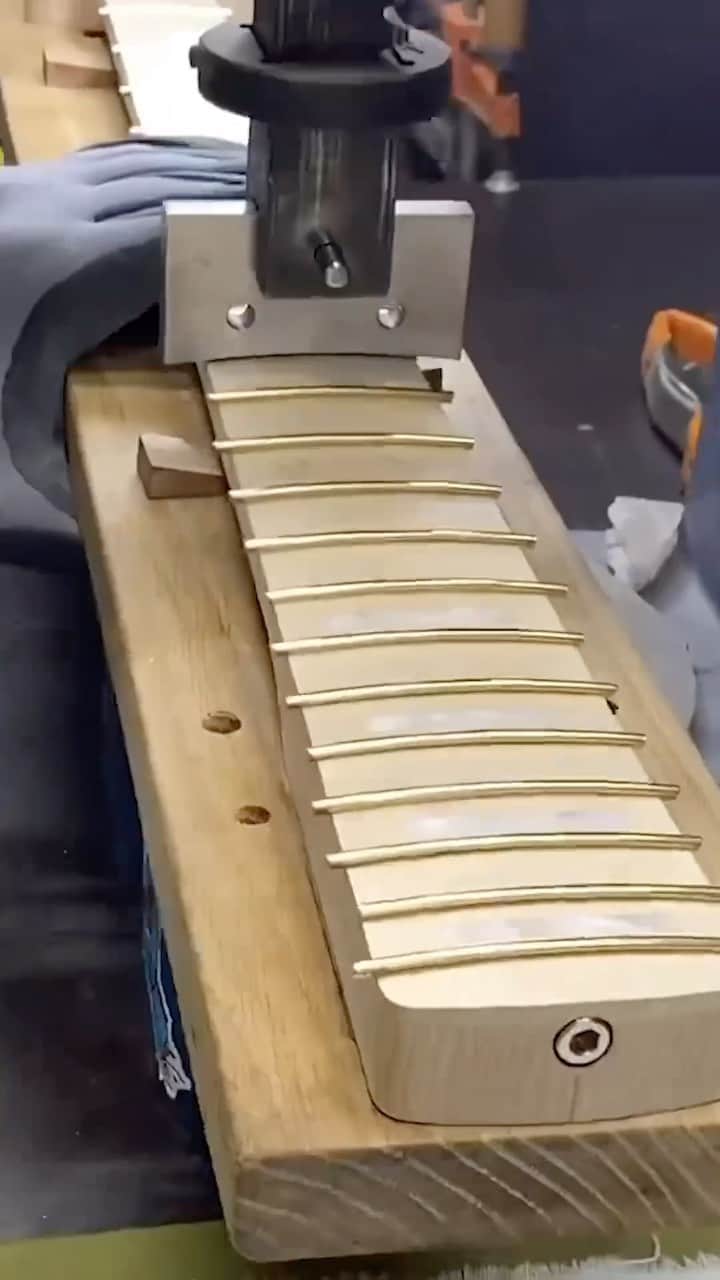 Fender Guitarのインスタグラム：「Take a seat with @mjmahk as he presses Gold frets on a @fendercustomshop bass neck. Do you prefer Gold or Silver hardware?  🎥: @dylanguitars」