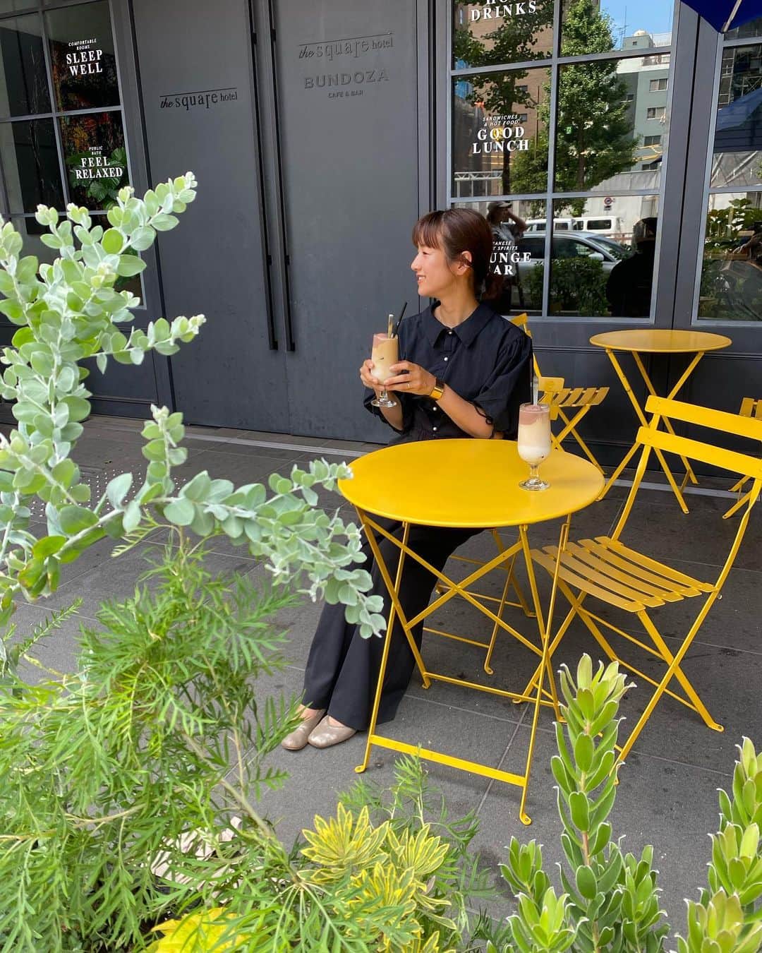 前田有紀のインスタグラム：「今年季節ごとの植栽を任せていただいている銀座のTHE SQUARE HOTEL GINZA @thesquarehotel_ginza さん。紫陽花の季節が過ぎたので、植栽を夏仕様に植え替えました。爽やかなリューカデンドロンをポイントに入れました。  一般的に商業用の庭仕事だと季節ごとに植え替える植物は捨ててしまうことも多くあり、私は問題解決したくて、まだ育てられるものは配ったり、庭に植え直したりしているのですが、このホテルではサステナブルな取り組みを大切にされているので、それまで植えていた植物も捨てない選択をしてくれています。時期の過ぎた紫陽花はプランターに植え替えてお渡しして来年まで頑張って育ててくださる予定です。  汗かきながら搬入していたのですが、作業後にヴィーガンアイスののったコーヒーフロートいただいて、それがとんでもなく美味しかったです。 銀座のお散歩の合間にテラスで、グリーンを眺めながらフロート楽しむのは最高な時間になりそうですね！  仕入れ、搬入、植え込みと力仕事のこの日は、ブラックコーデにパールボタンがアクセントになった　@o0u_official さんのブラウス。洗濯機で丸洗いできて、そのまま着れるのでありがたいです🤭」