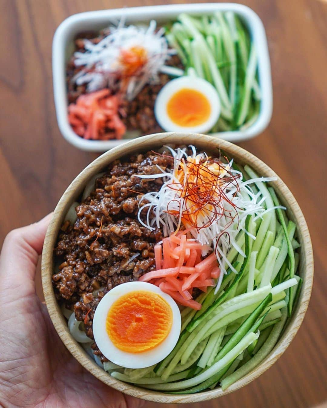 Chiharu Ko8yacのインスタグラム：「◯じゃじゃ麺弁当◯ ・ うどんに甜麺醤でつくる肉味噌をのせて ・ うどんは冷凍庫にかかさないテーブル◯ークのさぬき。肉味噌は筍無くてきのこだけ入り。 ・ この時期悩ましい“いたみ”の心配不要な冷めたいお弁当。 小さい豆乳をそれぞれつけて好みでかけていただきます☺︎ ・ 千切りスライサーが手放せない私ですが、こういうのって手切りの不揃い感がある方が断然美味しそうに見えませんこと？千切りキャベツもしかり。 今からでも練習したら上手くなれるかなー！？🥹 ・ #obento #bento #lunchbox #お弁当 #おべんとう#じゃじゃ麺#じゃじゃ麺弁当#麺弁当#ジャージャー麺#ジャージャー麺弁当#肉味噌#うどん弁当」