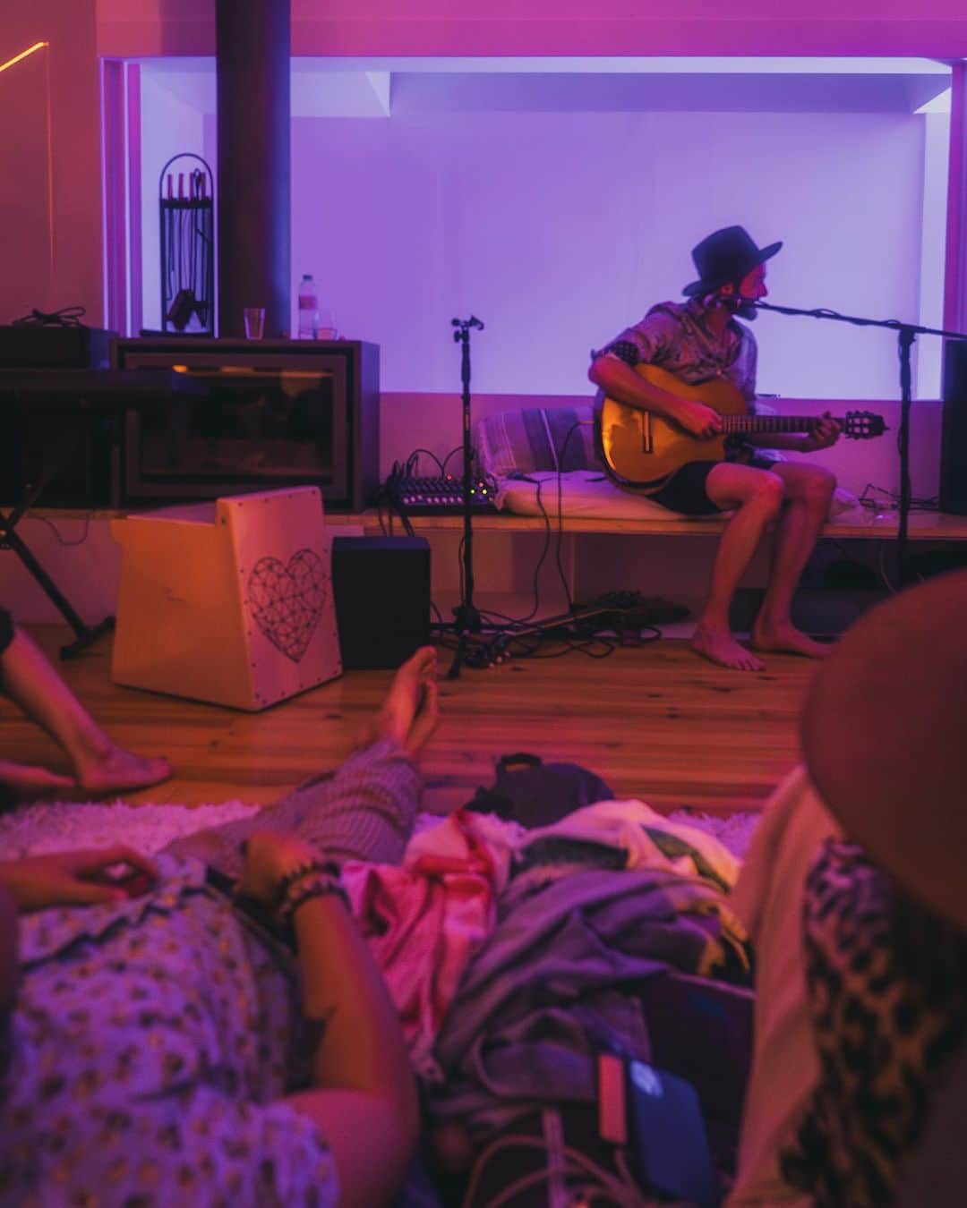 サイモンとマルティナのインスタグラム：「Last night, I spent an evening with @luvroya, and felt a vibe that I haven’t experienced before.  It was in a gorgeous apartment in Lisbon, with balconies on both sides, and, in the middle, a long couch, with many cushions spread across the floor.  In front of it all was a long bench with a couple of mics, and…fadoodliedad equipment that I can’t name because I have no musical understanding at all.   Thankfully, other people knew what to do, and they sat in front of a room of 25 of us or so, and shared their gifts of music.  We listened with love in our hearts, to some really talented people with positive messages to share.  It was…just gorgeous.  I was smiling all night long, with my heart full of joy and admiration, and my camera clicking away.  Here are some of my favorite shots from the night.  Thank you to @luvroya for hosting this community, to @future_fanzz for inviting me in, to @roamanmusic for his beautiful messaging, @bluedreamvisionary for sharing that delicious voice, and for the other people whose Instagram handles I didn’t get.   What a gorgeous night.  Much gratitude and appreciation to you all ❤️」