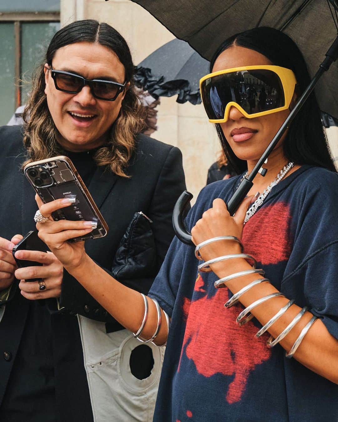 New York Times Fashionさんのインスタグラム写真 - (New York Times FashionInstagram)「Outside the men’s wear shows in Milan and Paris this month, fashion insiders showed up in inventive looks that included three-piece suits and graphic tees. Pharrell Williams, the new Louis Vuitton men’s creative director, wore a Kenzo jacket-and-shorts set.  The photographer @simbarashecha spent 10 days observing the fashion on the streets of Milan and Paris, where neck scarves were a potent accessory and the few who had traditional neckties wore them atypically, including with collarless shirts.  “It’s not a stretch to say that men’s wear has long been seen by many as simpler and less creative than women’s wear,” he writes. “But as more men have found ways to personalize even the most traditional staples, they have shown that there are far wider possibilities than once thought.”  Others on the street revived a fad popularized in the early 1990s by the hip-hop duo Kriss Kross: wearing blazers and shirts in reverse, so the buttons and lapels were on the back. And there were various graphic tops with popular culture references, including a fisherman’s sweater with an image of Kurt Cobain’s face and a sleeveless tunic featuring the album cover of “Substance” by New Order.  See more style outside from recent fashion weeks at the link in bio. Photos by @simbarashecha」6月29日 1時42分 - nytstyle