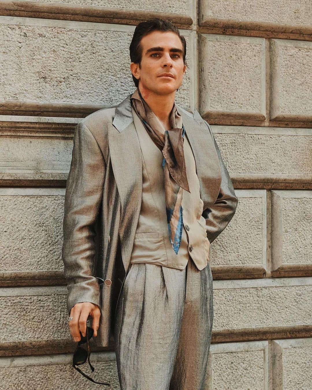 New York Times Fashionさんのインスタグラム写真 - (New York Times FashionInstagram)「Outside the men’s wear shows in Milan and Paris this month, fashion insiders showed up in inventive looks that included three-piece suits and graphic tees. Pharrell Williams, the new Louis Vuitton men’s creative director, wore a Kenzo jacket-and-shorts set.  The photographer @simbarashecha spent 10 days observing the fashion on the streets of Milan and Paris, where neck scarves were a potent accessory and the few who had traditional neckties wore them atypically, including with collarless shirts.  “It’s not a stretch to say that men’s wear has long been seen by many as simpler and less creative than women’s wear,” he writes. “But as more men have found ways to personalize even the most traditional staples, they have shown that there are far wider possibilities than once thought.”  Others on the street revived a fad popularized in the early 1990s by the hip-hop duo Kriss Kross: wearing blazers and shirts in reverse, so the buttons and lapels were on the back. And there were various graphic tops with popular culture references, including a fisherman’s sweater with an image of Kurt Cobain’s face and a sleeveless tunic featuring the album cover of “Substance” by New Order.  See more style outside from recent fashion weeks at the link in bio. Photos by @simbarashecha」6月29日 1時42分 - nytstyle