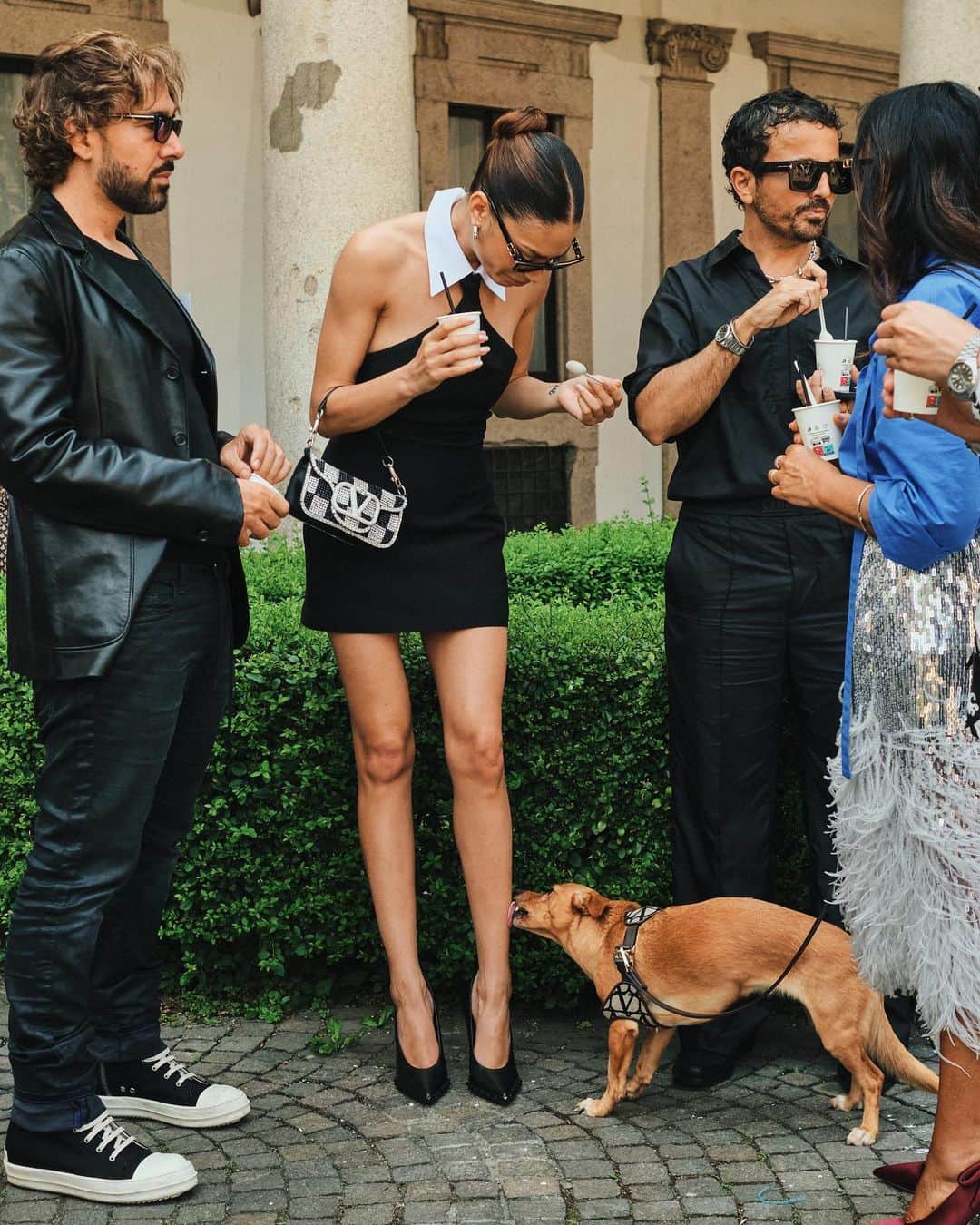 New York Times Fashionさんのインスタグラム写真 - (New York Times FashionInstagram)「Outside the men’s wear shows in Milan and Paris this month, fashion insiders showed up in inventive looks that included three-piece suits and graphic tees. Pharrell Williams, the new Louis Vuitton men’s creative director, wore a Kenzo jacket-and-shorts set.  The photographer @simbarashecha spent 10 days observing the fashion on the streets of Milan and Paris, where neck scarves were a potent accessory and the few who had traditional neckties wore them atypically, including with collarless shirts.  “It’s not a stretch to say that men’s wear has long been seen by many as simpler and less creative than women’s wear,” he writes. “But as more men have found ways to personalize even the most traditional staples, they have shown that there are far wider possibilities than once thought.”  Others on the street revived a fad popularized in the early 1990s by the hip-hop duo Kriss Kross: wearing blazers and shirts in reverse, so the buttons and lapels were on the back. And there were various graphic tops with popular culture references, including a fisherman’s sweater with an image of Kurt Cobain’s face and a sleeveless tunic featuring the album cover of “Substance” by New Order.  See more style outside from recent fashion weeks at the link in bio. Photos by @simbarashecha」6月29日 1時42分 - nytstyle