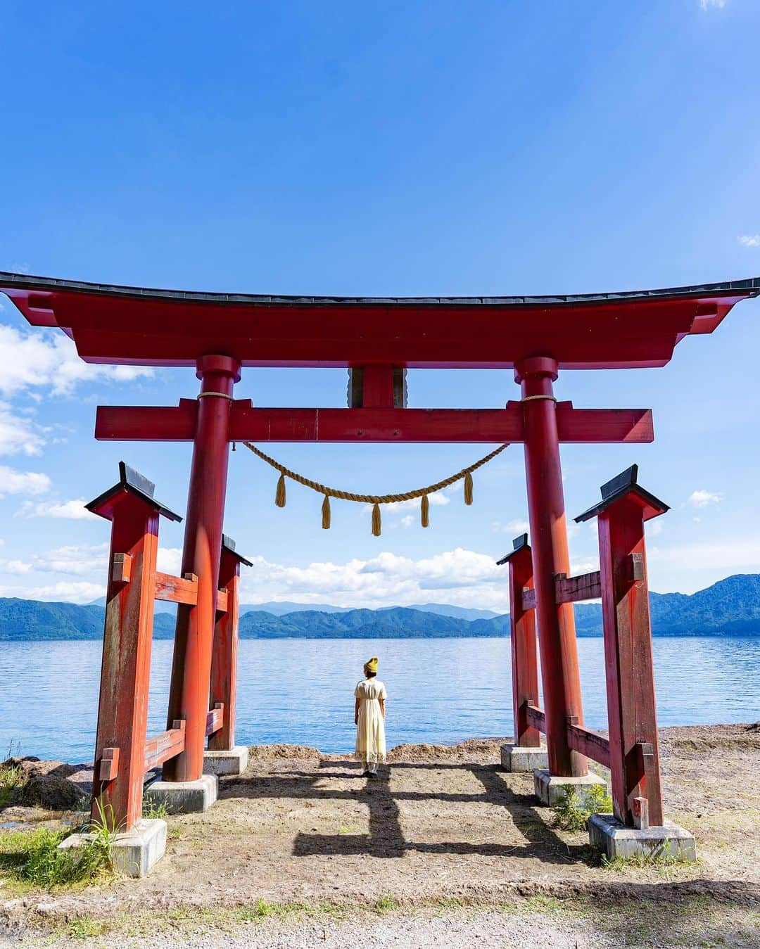 詩歩のインスタグラム：「📷 20th June 2023 📍 秋田県 御座石神社 / Gozano-ishi shirine , Akita Japan   日本一深い田沢湖のほとりに佇む朱色の鳥居  これは #御座石神社 の鳥居で、美の神様である”たつこ姫”を祀る神社です。そう、たつこ姫とは田沢湖にあるあの有名な #たつこ像 のこと！（像は湖の反対側に）  御座石（ござのいし）というのは、かつて秋田藩主が田沢湖を遊覧したとき、ここに腰をかけて休んだことが由来だそう。  田沢湖は来たことあったけど、夏は初めて。光が差し込んだ瞬間の湖の色が！！　もう歓声をあげてしまうほどの透明度と青さ✨  一体どこまで続くか分からないその恐ろしさも含め、ずーっとコバルトブルーに輝くその湖の中から目が離せませんでした。  秋田県の他の写真はこのタグでまとめています / Posts of this area can be found in this tag.→ #shiho_akita   A vermilion #torii gate standing by #LakeTazawa , the deepest lake in Japan This is the torii of #GozainoshiShrine , a shrine dedicated to "Princess Tatsuko," the goddess of beauty. Yes, Princess Tatsuko is the famous statue of #Tatsuko on Lake Tazawa (the statue is on the other side of the lake)! The name "Goza-no-ishi" comes from the fact that the lord of the Akita Clan used to sit and rest here when he toured Lake Tazawa.  I had been here before, but this was my first time in summer. The lake is so clear and blue that when the light shines through, you can't help but shout with delight . I couldn't take my eyes off that cobalt blue lake the whole time, including that scary feeling of not knowing how far it goes.  ©︎Shiho/詩歩」