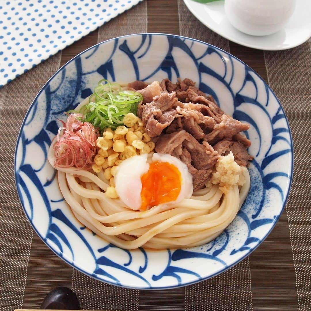 テーブルマークのインスタグラム：「. 夏うどん🎐 【冷やし牛玉うどん】 . 甘辛く味付けした牛肉と コシのあるさぬきうどんは相性抜群😉💯 . ▼材料（１人分） ❁冷凍「さぬきうどん」：１玉 ❁牛薄切り肉：100g ❁めんつゆ（ストレート）：適宜 ［A］ ❁砂糖：小さじ1/2 ❁しょうゆ：小さじ２ ❁みりん：小さじ２ ❁酒：小さじ１ ［B］ ❁温泉卵：１個 ❁しょうが（おろす）：１かけ（10g） ❁みょうが（小口切り）：１個 ❁青ねぎ（小口切り）：適量（約10g） ❁揚げ玉：適量（大さじ1～2） . ▼作り方 ①牛薄切り肉を耐熱容器に入れ、 　［A］をよくからめる . ②冷凍「さぬきうどん」はレンジで加熱し、 　冷水で洗ってざるにあげる . ③水でしめたさぬきうどんを皿に盛り付け、 　①を汁ごとのせる . ④［B］をのせ、めんつゆを添えて召し上がれ . #うどん #udon #冷凍うどん #さぬきうどん #うどん部 #うどん好き #レシピ #おうちごはん #簡単レシピ #うどんレシピ #アレンジレシピ #今日のごはん #ランチ #ランチメニュー #夕食 #晩御飯 #晩ご飯 #晩ごはん #TableMark #テーブルマーク #牛肉 #揚げ玉 #温泉卵 #夏うどん #夏 #夏レシピ #夏メニュー」