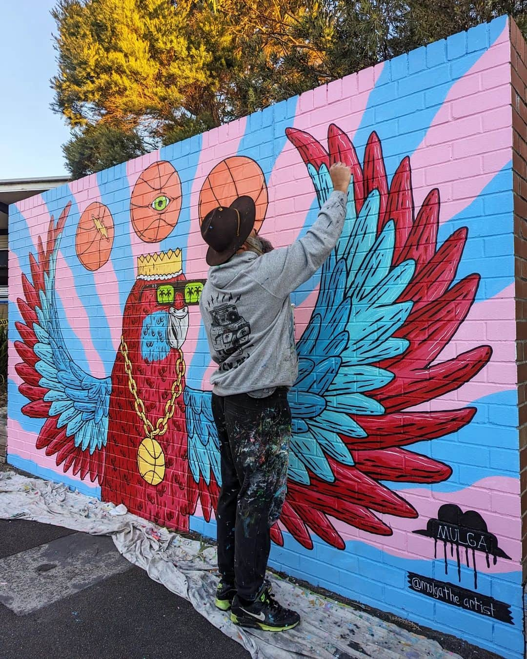 MULGAさんのインスタグラム写真 - (MULGAInstagram)「Fun times painting a B-ball Rosella mural over 2 days at Lucas Heights Community School last week.⁣ ⁣ I did a celebratory dunk after I finished*.⁣ ⁣ The story of Randy the Rosella ⁣ ⁣ Once there was a Rosella called Randy and  he enjoyed playing basketball immensely and was actually pretty good at it. ⁣ ⁣ He rose to the pinnacle of the ABL (Aviary Basketball League) and won a few championships before a big scandal erupted and he was given a life ban from playing in ABL. ⁣ ⁣ The reason he was banned was because it was discovered that he was using his magical telekinetic powers to control the basketball in games. Basically whenever he took a shot he was able to telekinetically cause the ball to always go in the hoop. ⁣ ⁣ He didn't always have those powers and he only got them one day when he was rummaging around at his local dump and ate a radioactive gummy worm that he found. ⁣ ⁣ Anyhow, after he was banned he developed and toured a show around the country where he did heaps of cool telekinetic tricks and stuff. It was mad popular and kept him busy for years. ⁣ ⁣ The End ⁣ ⁣ *Not true.⁣ ⁣ #mulgatheartist #art #artistsoninstagram #artoftheday #artwork #artofinstagram #australianart #australianartist #artistic #muralartist #muralart #mural #muralist #artworking #painting #schoolmural #rosella #basketballart #rosellapainting」7月1日 17時23分 - mulgatheartist