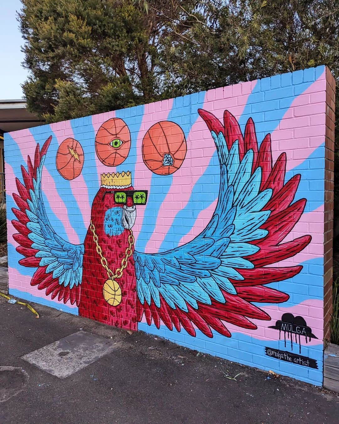 MULGAさんのインスタグラム写真 - (MULGAInstagram)「Fun times painting a B-ball Rosella mural over 2 days at Lucas Heights Community School last week.⁣ ⁣ I did a celebratory dunk after I finished*.⁣ ⁣ The story of Randy the Rosella ⁣ ⁣ Once there was a Rosella called Randy and  he enjoyed playing basketball immensely and was actually pretty good at it. ⁣ ⁣ He rose to the pinnacle of the ABL (Aviary Basketball League) and won a few championships before a big scandal erupted and he was given a life ban from playing in ABL. ⁣ ⁣ The reason he was banned was because it was discovered that he was using his magical telekinetic powers to control the basketball in games. Basically whenever he took a shot he was able to telekinetically cause the ball to always go in the hoop. ⁣ ⁣ He didn't always have those powers and he only got them one day when he was rummaging around at his local dump and ate a radioactive gummy worm that he found. ⁣ ⁣ Anyhow, after he was banned he developed and toured a show around the country where he did heaps of cool telekinetic tricks and stuff. It was mad popular and kept him busy for years. ⁣ ⁣ The End ⁣ ⁣ *Not true.⁣ ⁣ #mulgatheartist #art #artistsoninstagram #artoftheday #artwork #artofinstagram #australianart #australianartist #artistic #muralartist #muralart #mural #muralist #artworking #painting #schoolmural #rosella #basketballart #rosellapainting」7月1日 17時23分 - mulgatheartist