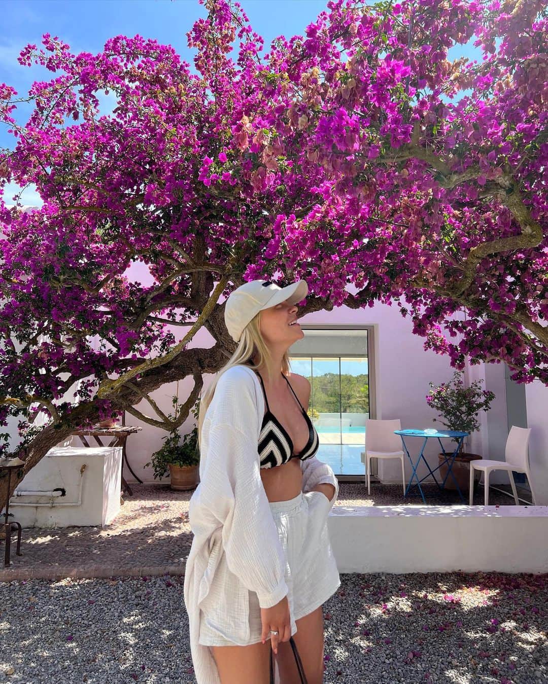Dagi Beeのインスタグラム：「Our little safe place on Ibiza ✨🌸☀️🌴🍋   Outfit Details :  Cap : @casa_mara  Bikini : @calzedonia  Set : @sassyclassy  Bag : @loewe  Sandals : @birkenstock」