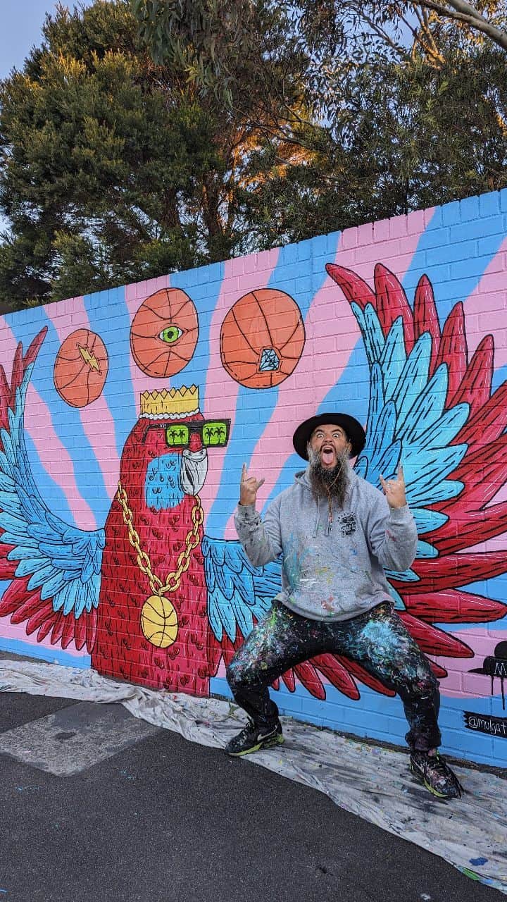 MULGAのインスタグラム：「Randy the Rosella mural at Lucas Heights Community School 🏀🦜🏀.⁣ ⁣ Here's the timelapse video filmed on a GoPro cutting down about 18 hrs of painting into under a minute ⏳⁣ ⁣ The story of Randy the Rosella ⁣ ⁣ Once there was a Rosella called Randy and  he enjoyed playing basketball immensely and was actually pretty good at it. ⁣ ⁣ He rose to the pinnacle of the ABL (Aviary Basketball League) and won a few championships before a big scandal erupted and he was given a life ban from playing in ABL. ⁣ ⁣ The reason he was banned was because it was discovered that he was using his magical telekinetic powers to control the basketball in games. Basically whenever he took a shot he was able to telekinetically cause the ball to always go in the hoop. ⁣ ⁣ He didn't always have those powers and he only got them one day when he was rummaging around at his local dump and ate a radioactive gummy worm that he found. ⁣ ⁣ Anyhow, after he was banned he developed and toured a show around the country where he did heaps of cool telekinetic tricks and stuff. It was mad popular and kept him busy for years. ⁣ ⁣ The End⁣ ⁣ #mulgatheartist #art #artistsoninstagram #artoftheday #artwork #artofinstagram #australianart #australianartist #artistic #muralartist #muralart #mural #muralist #artworking #painting #schoolmural #rosella #basketballart #rosellapainting #timelapse #gopro #goproaus #timelapsevideo #timelapsepainting」