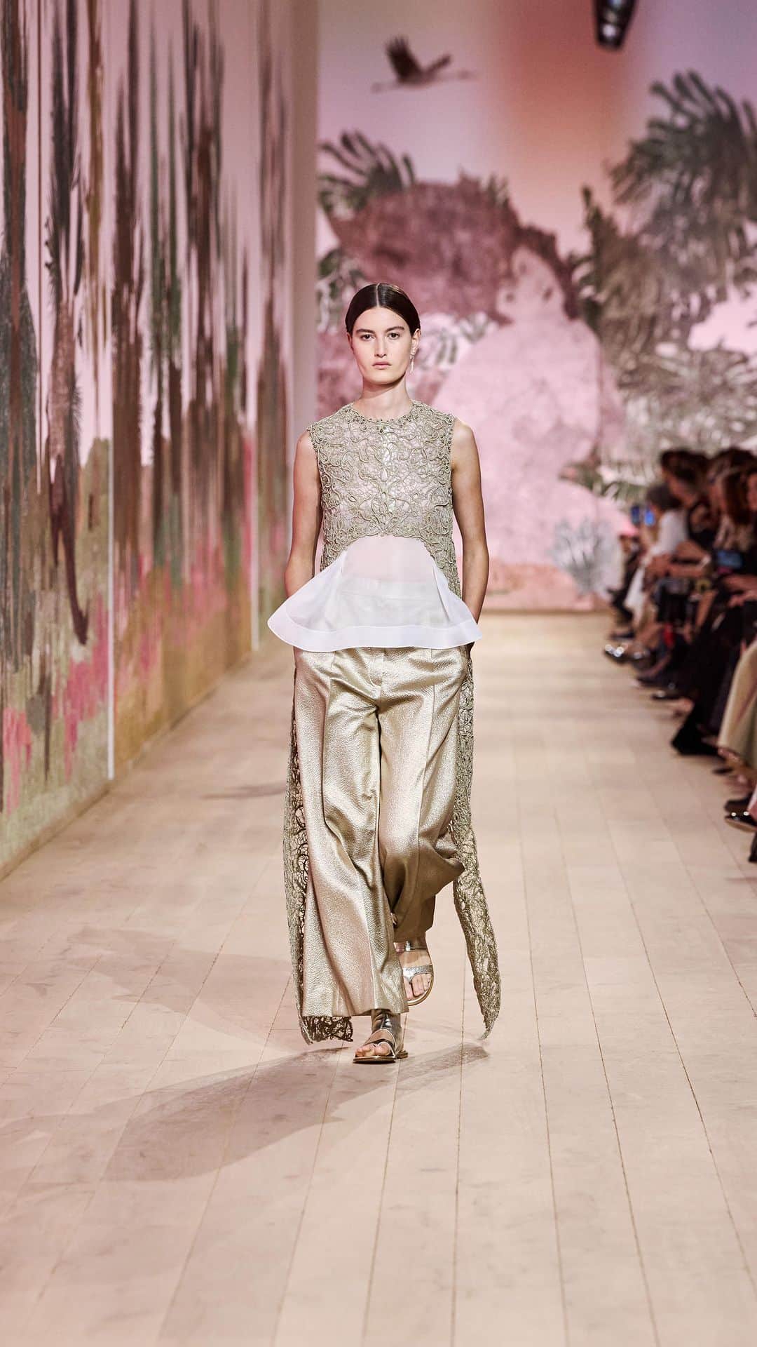 のインスタグラム：「With the unparalleled expertise of the House's own petites mains and a number of external, specialist ateliers at her disposal, @MariaGraziaChiuri brought the best of #DiorSavoirFaire to bear on the embellishment of the newly unveiled #DiorCouture Autumn-Winter 2023-2024 collection. As pictured here, a cut-out, cape-effect trailing top is constructed from silver guipure, while the meticulous art of drawn threadwork opens up geometric windows into a shantung dress. Meanwhile, gilded lace is pleated, piped and pieced into ethereal layers, and a beaded mesh cape glides airily over a bib-front blouse and trousers. © Music: "Again And Again" by @NotWaving_」