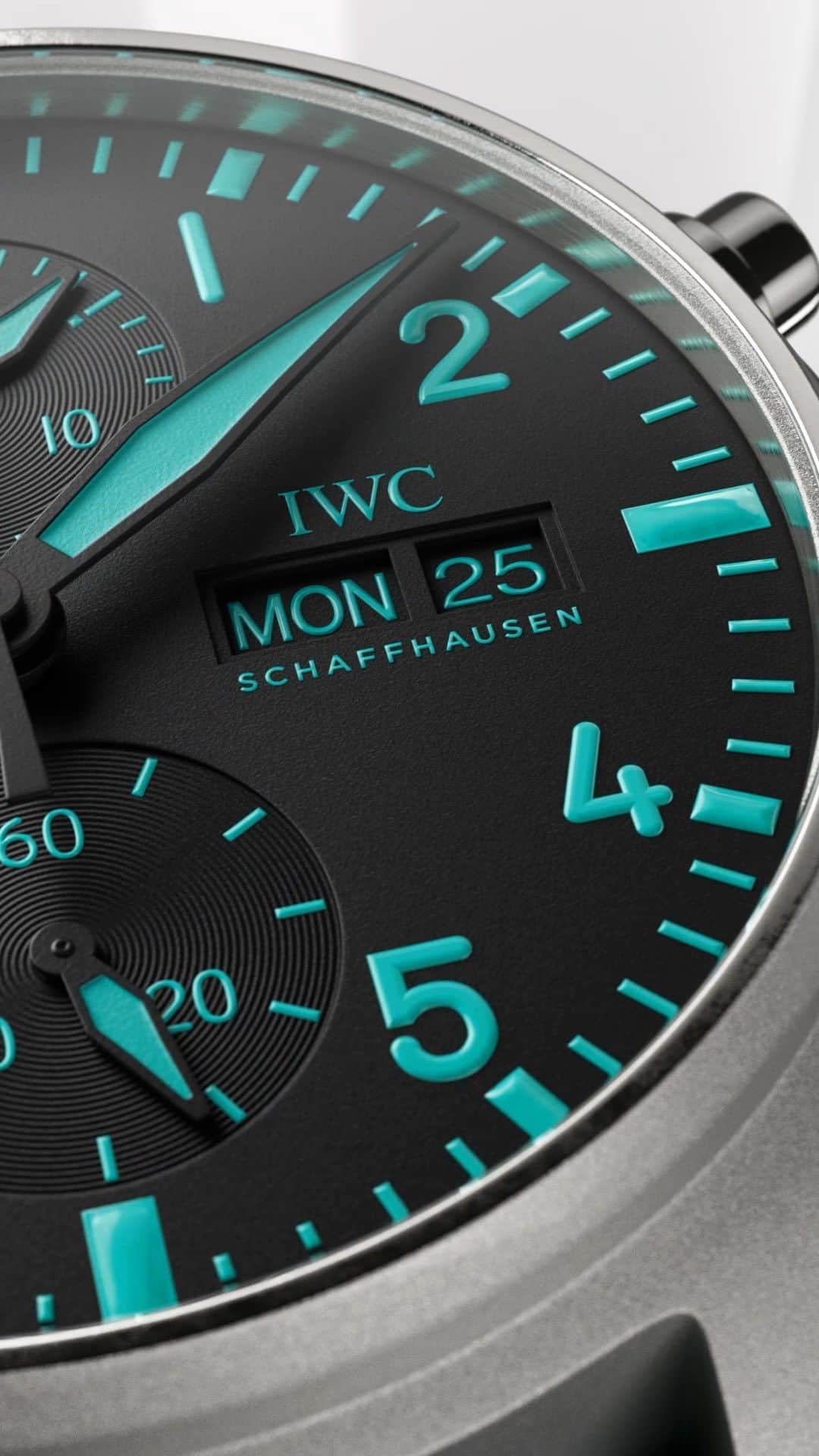 IWCのインスタグラム：「Reliability and precision at every second.  Crafted from lightweight and remarkably rigid grade 5 titanium this chronograph is delivered with two different straps: one black embossed calfskin strap, and one green rubber strap. Thanks to the integrated EasX-CHANGE®, the straps can be exchanged quickly and easily at the touch of a button without additional tools.  🔗Link in Bio  Ref. IW388108 - Pilot’s Watch Chronograph 41 Edition “MERCEDES-AMG PETRONAS FORMULA ONE™ TEAM”  #IWCpilot | #TheReference   ℹ Black Dial Titanium case 41mm EasX-CHANGE system IWC-manufactured 69385 Calibre」